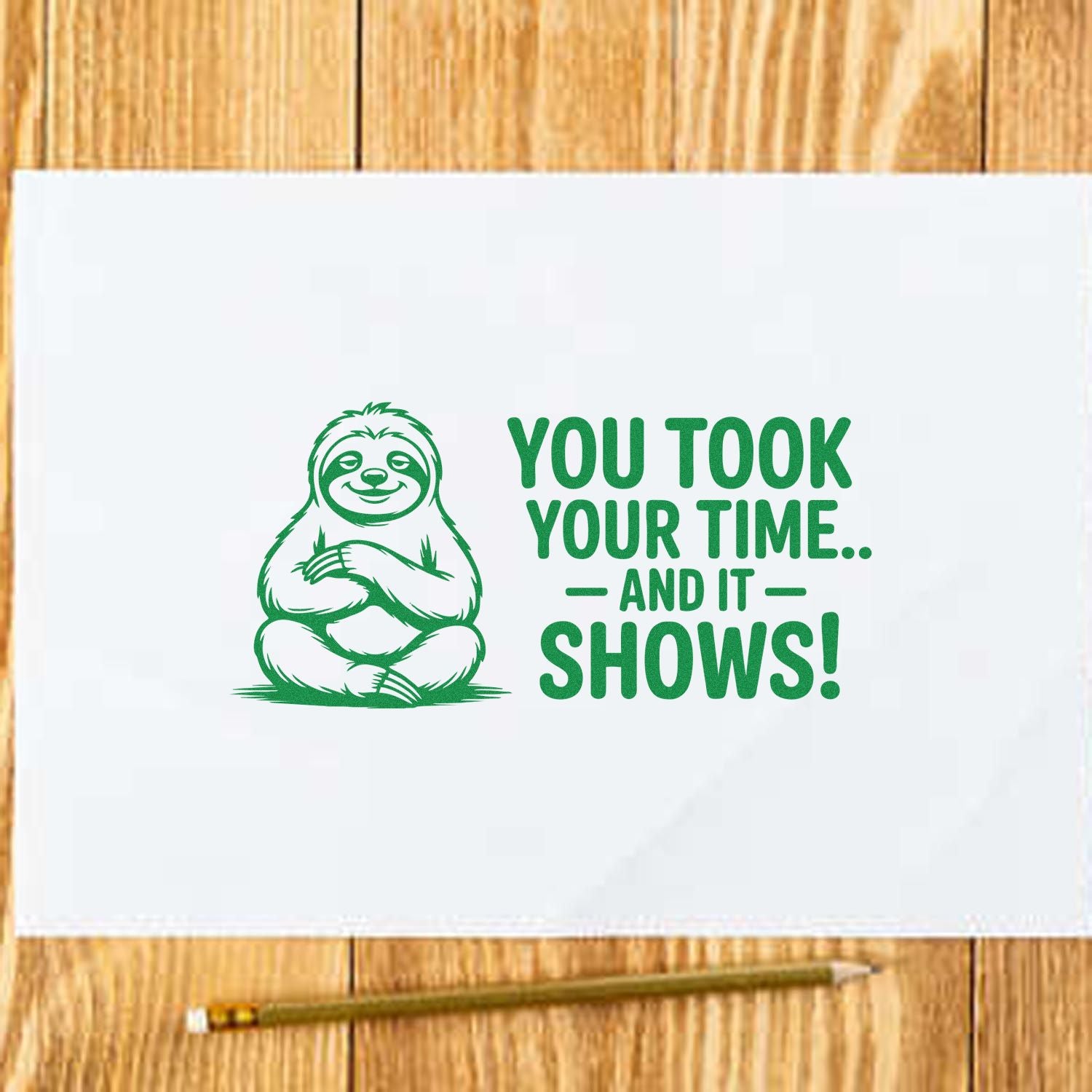 Green sloth stamp and seal design with You took your time... and it shows! in green on white paper over wood.
