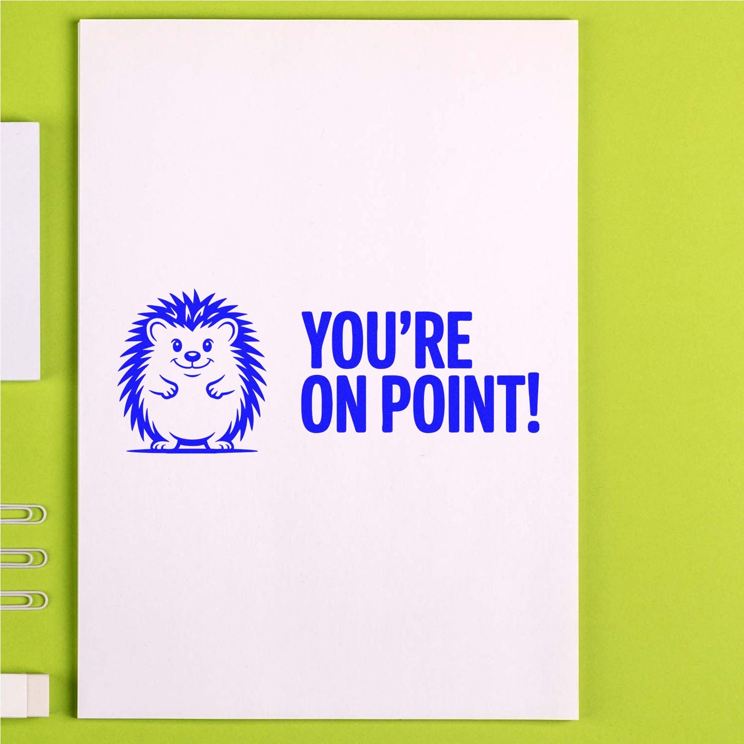Blue hedgehog stamp and seal with YOURE ON POINT! on white paper, on a lime green background.