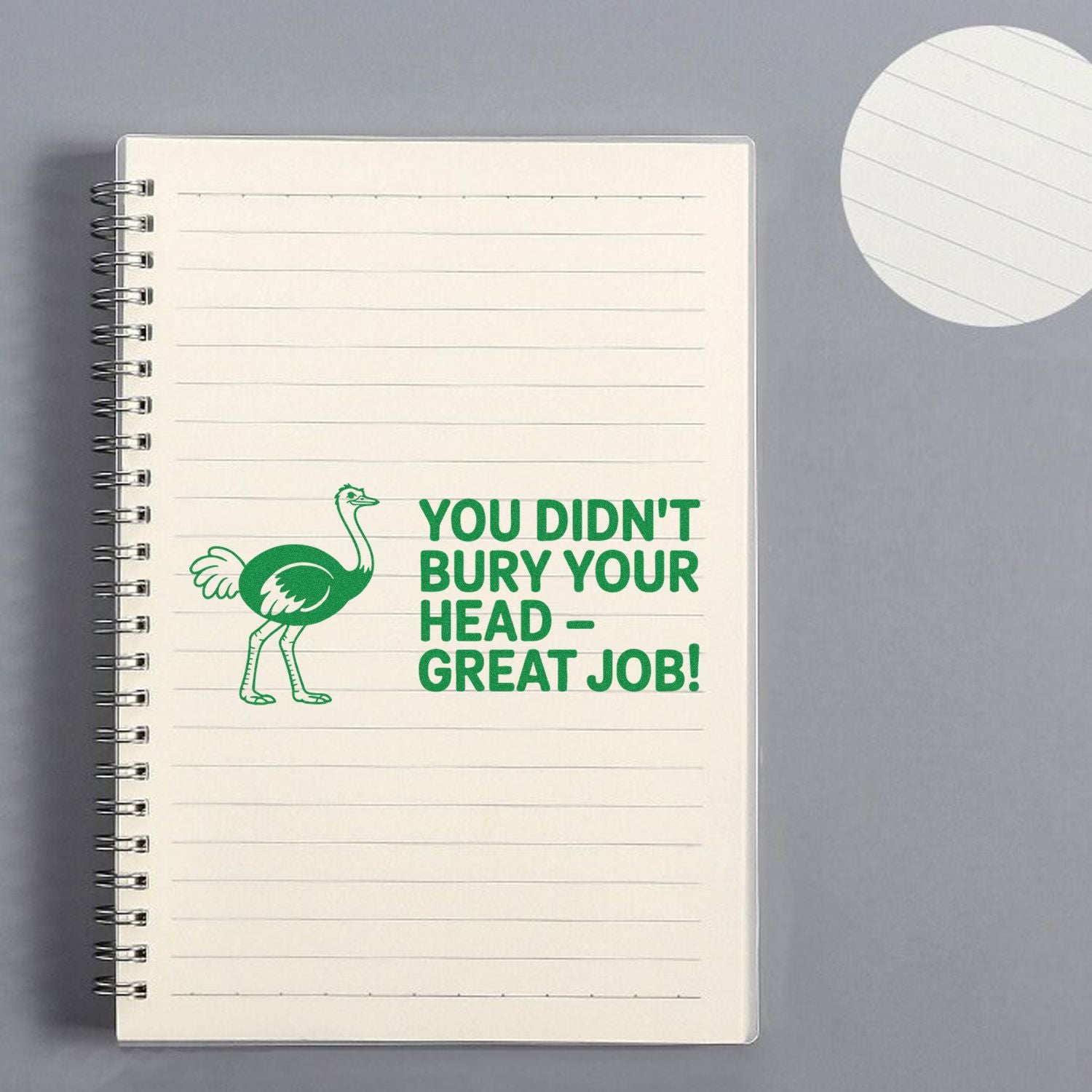Green ostrich stamp and seal imprint with bold text You didnt bury your head  great job! on lined notebook.