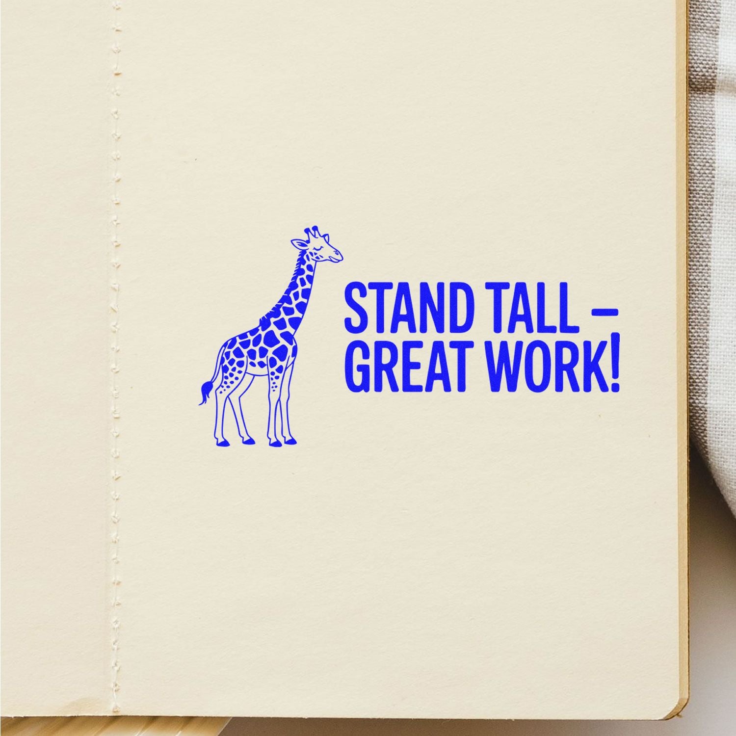 Blue giraffe stamp and seal reading STAND TALL  GREAT WORK! on cream paper.