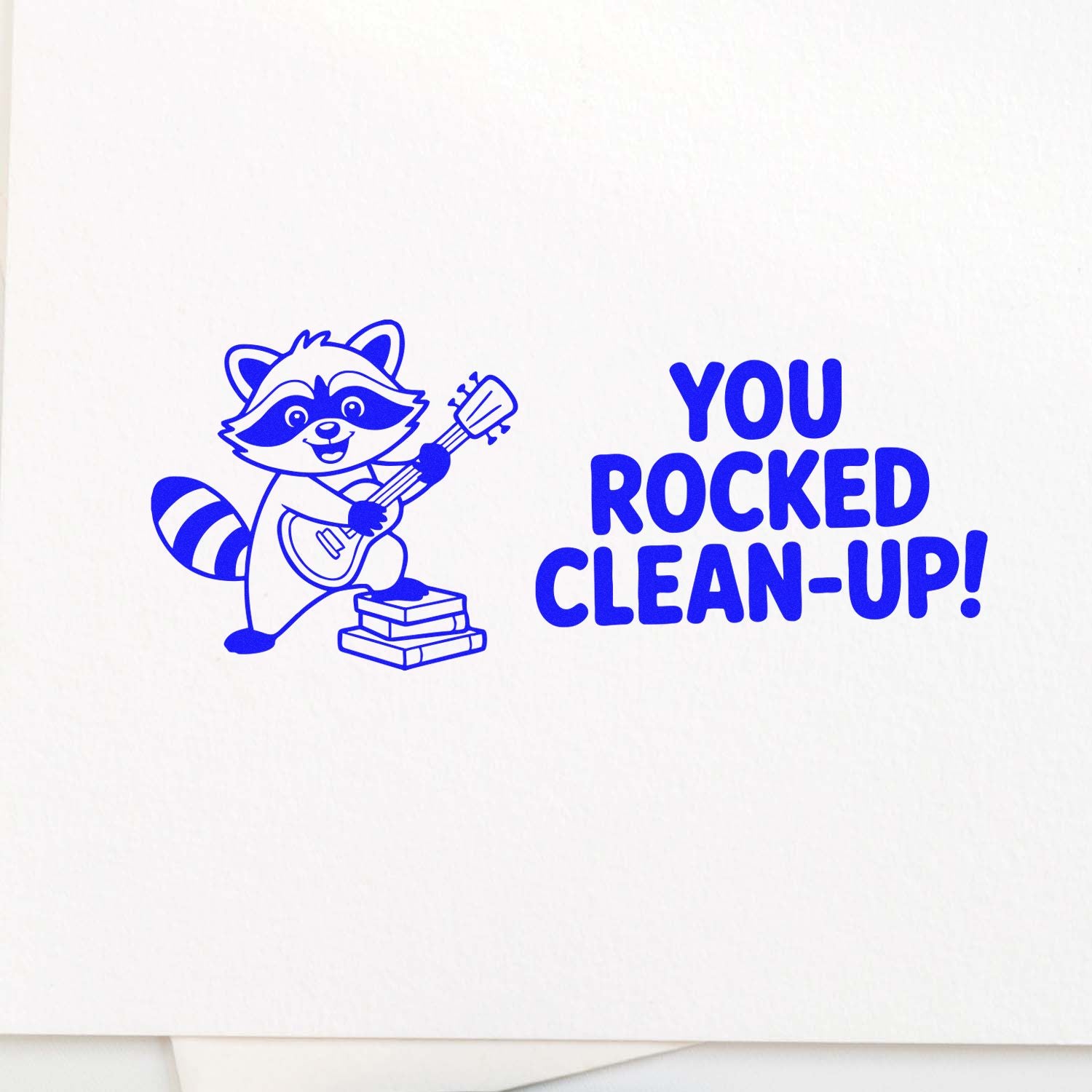 Blue cleanup stamp and seal with a raccoon playing guitar and bold You Rocked Clean-Up! text on white.