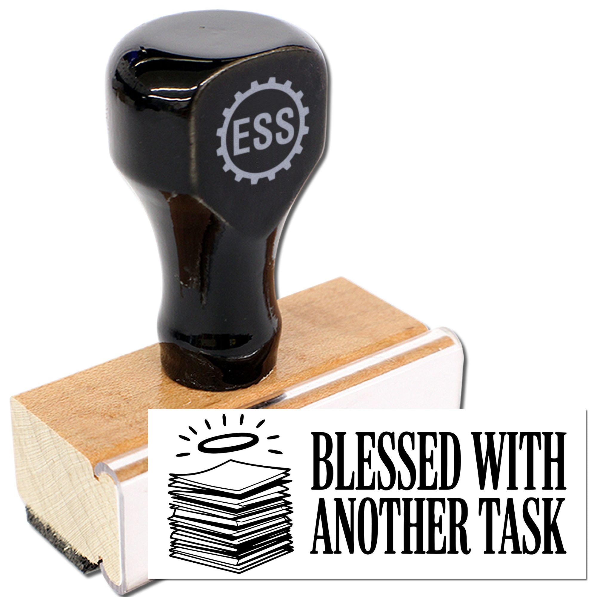 Black rubber stamp with tan wooden base and white seal reading Blessed With Another Task, plus ESS gear logo.