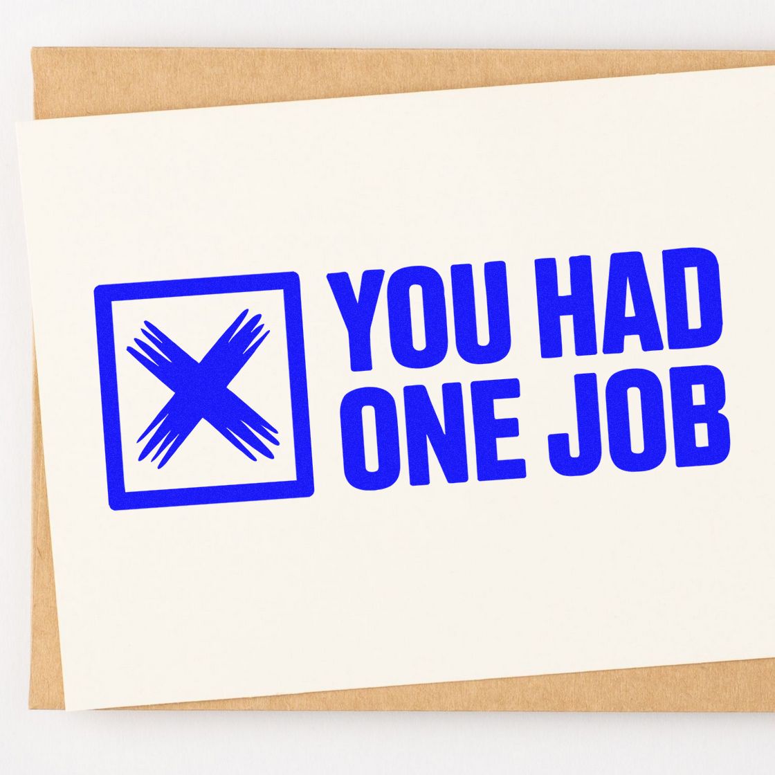 Blue YOU HAD ONE JOB rubber stamp and seal design with crossed box icon on white card over tan kraft paper.