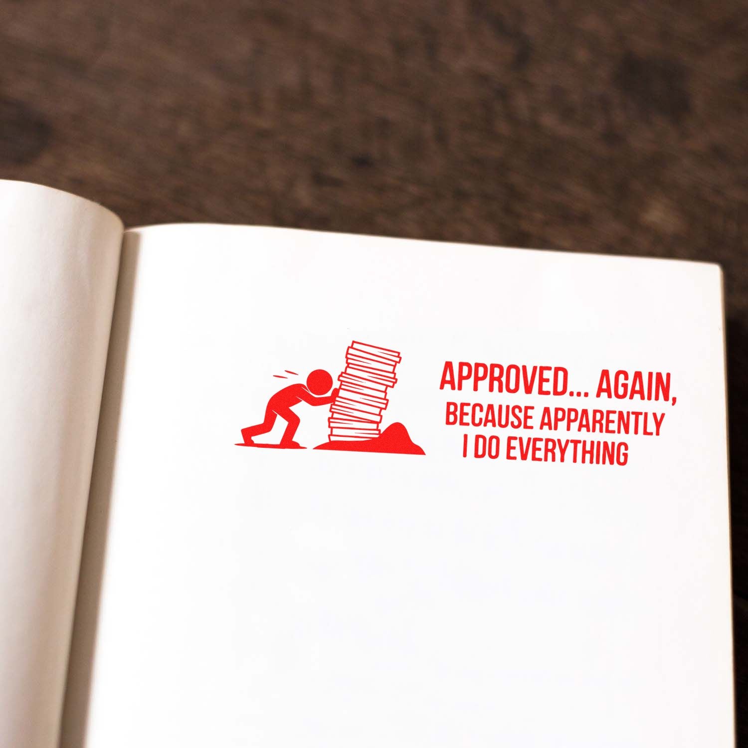 Red approval stamp and seal on white paper, with figure pushing stacked documents and text Approved... Again
