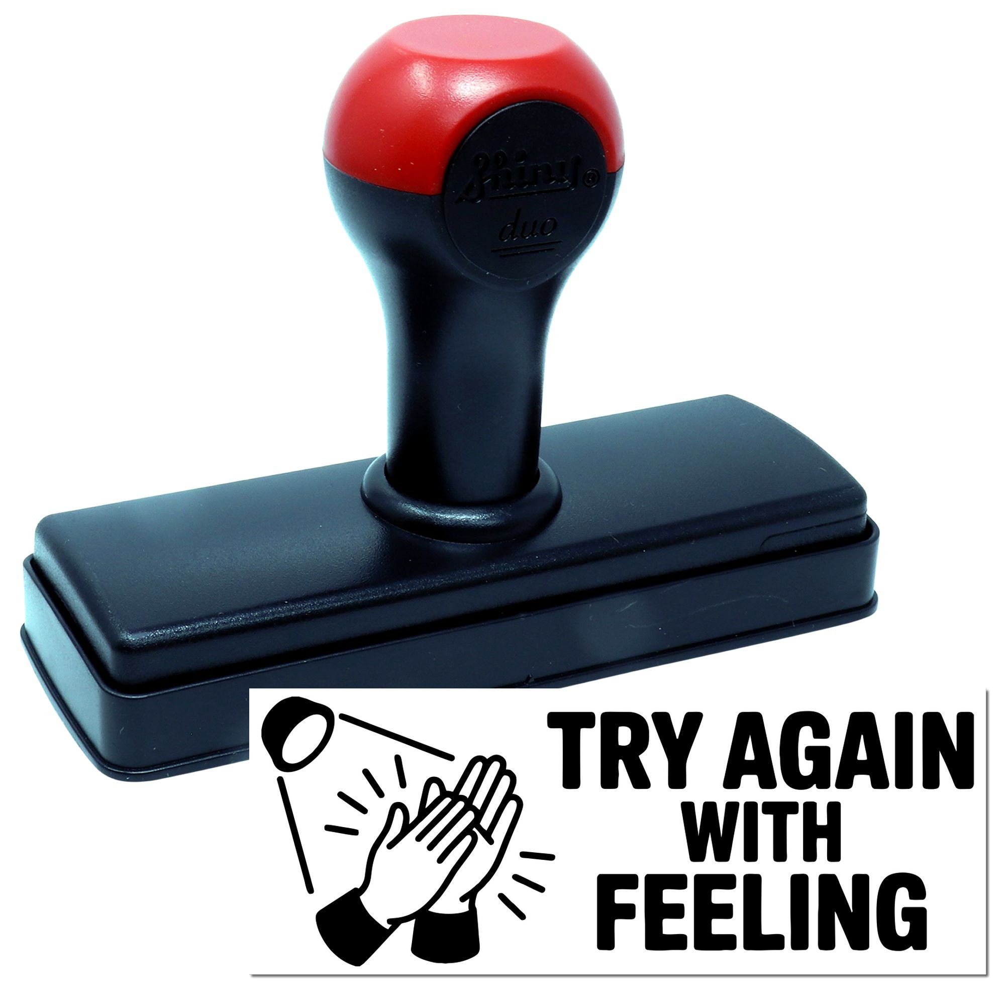 Red and black self-inking stamp on a black base beside a TRY AGAIN WITH FEELING seal graphic.
