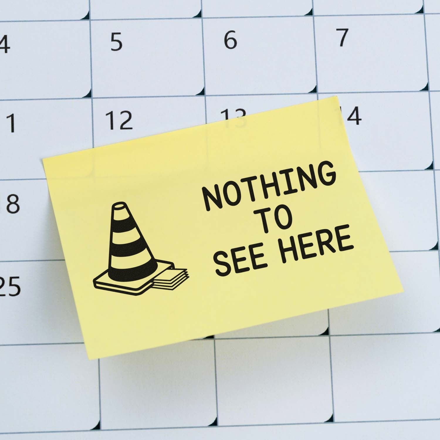 Yellow sticky-note stamp seal with black cone icon and NOTHING TO SEE HERE over a calendar.
