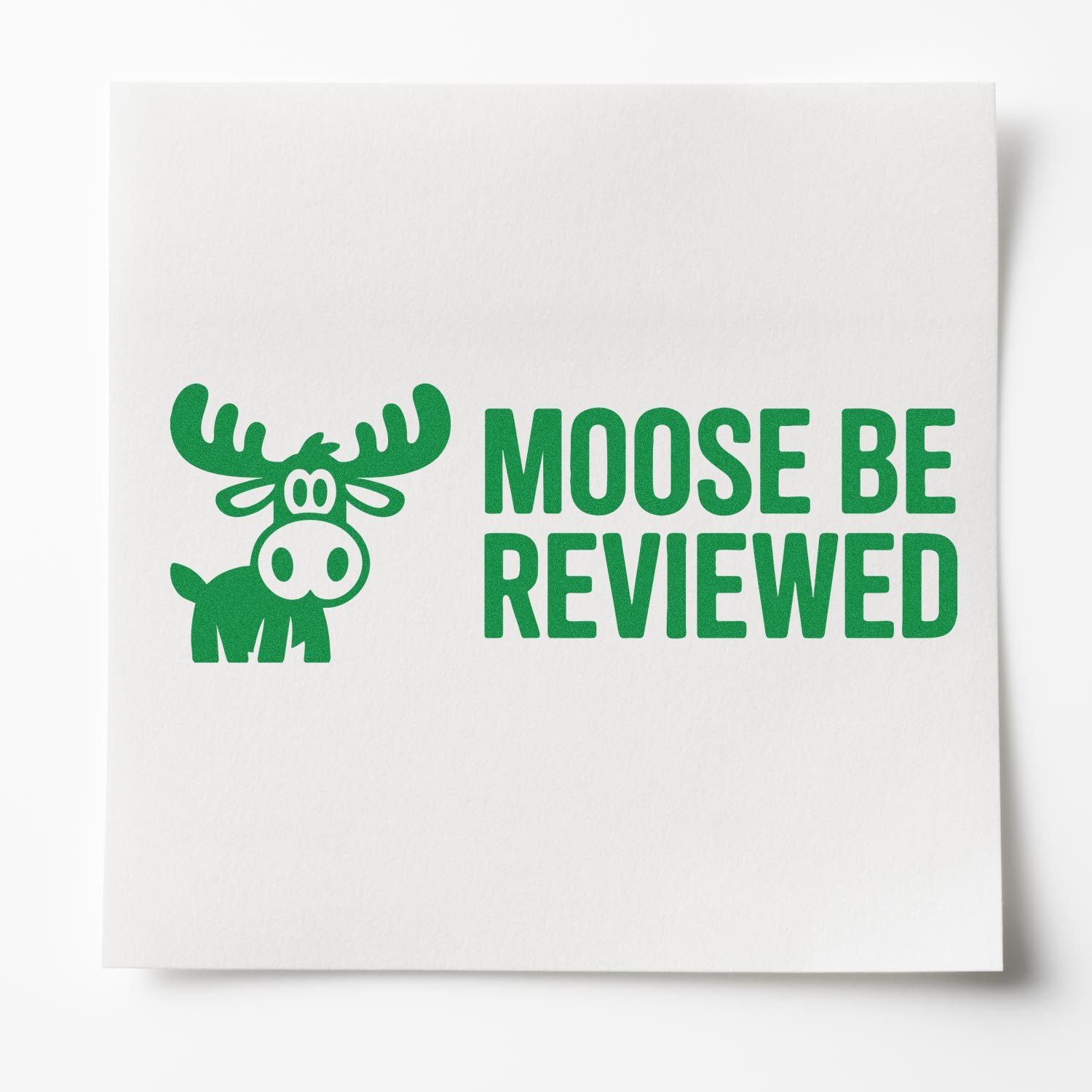 Green moose review stamp on white paper seal card with bold MOOSE BE REVIEWED text.