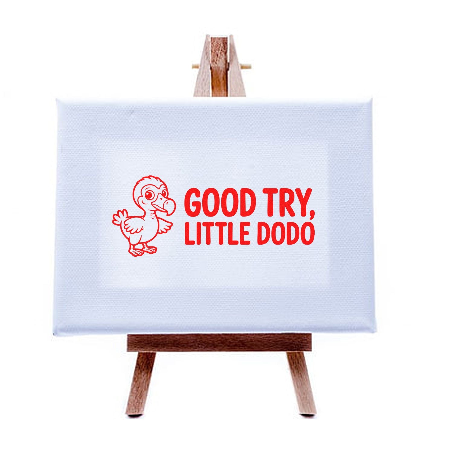 Red dodo stamp on light blue seal canvas, with bold red text GOOD TRY, LITTLE DODO on a wooden easel.