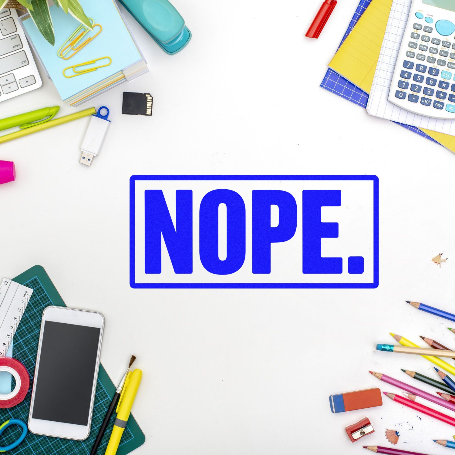 Blue NOPE. stamp seal on a white desk, surrounded by colorful school supplies, calculator, phone, pens, and pencils.