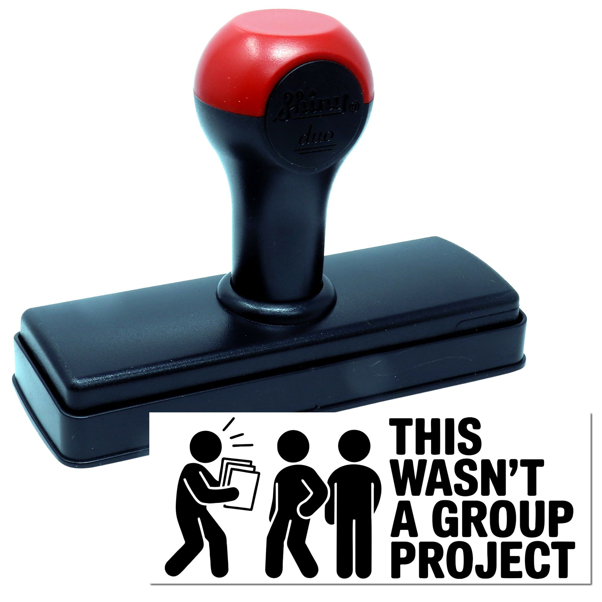 Red and black self-inking stamp and seal with This wasnt a group project bold black imprint and stick-figure graphic.