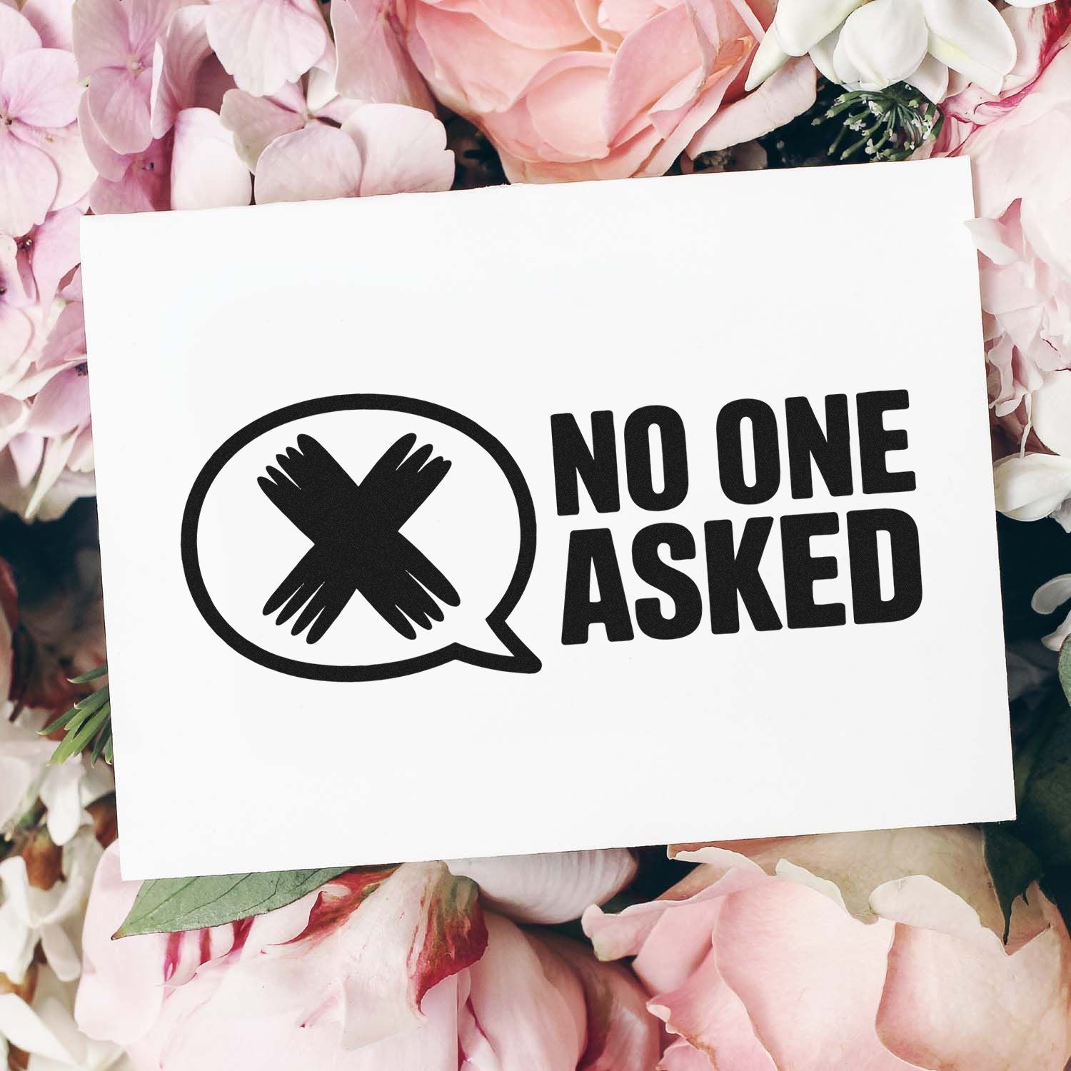Black NO ONE ASKED stamp design with crossed-hands speech bubble on white card, surrounded by soft pink flowers.