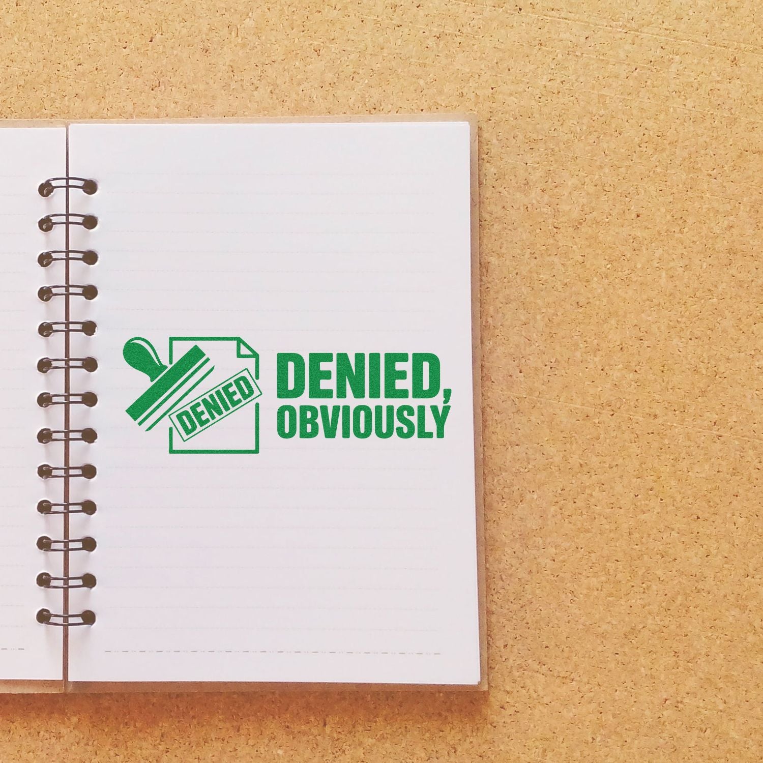 Green denied stamp and seal design on a lined notebook page, with bold green text and spiral binding on a tan background.
