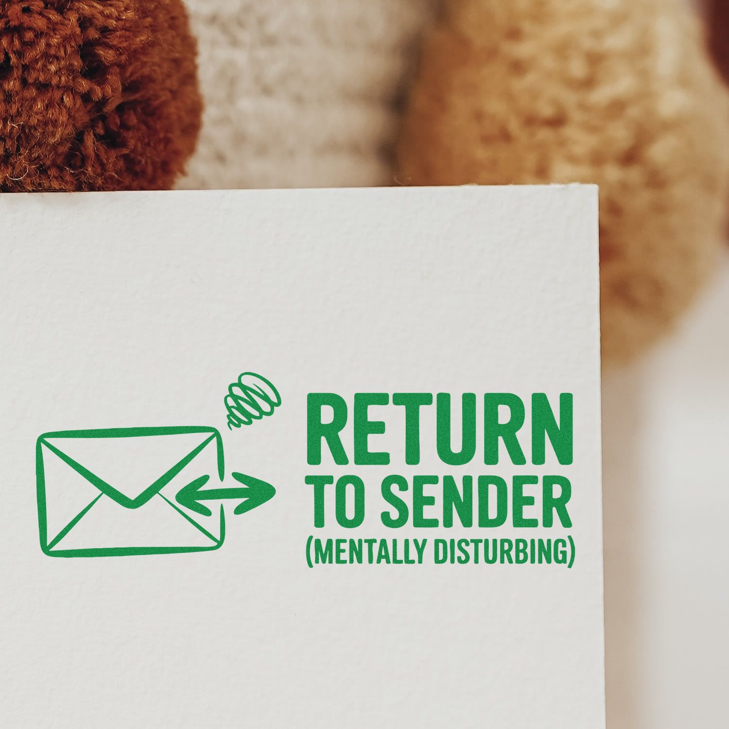 Green return-to-sender stamp seal with envelope icon and MENTALLY DISTURBING on white paper.