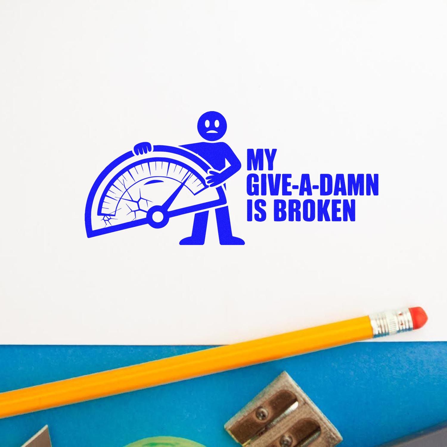 Blue rubber stamp impression reading My give-a-damn is broken with a cracked gauge graphic on white paper.