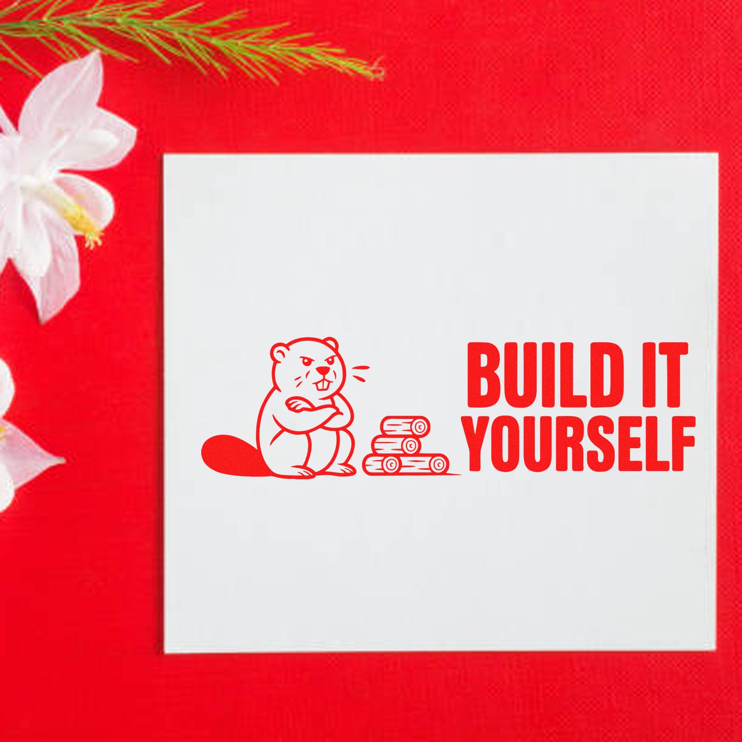 Red stamp seal with beaver and logs, white card, bold BUILD IT YOURSELF text on a red background with white flowers.