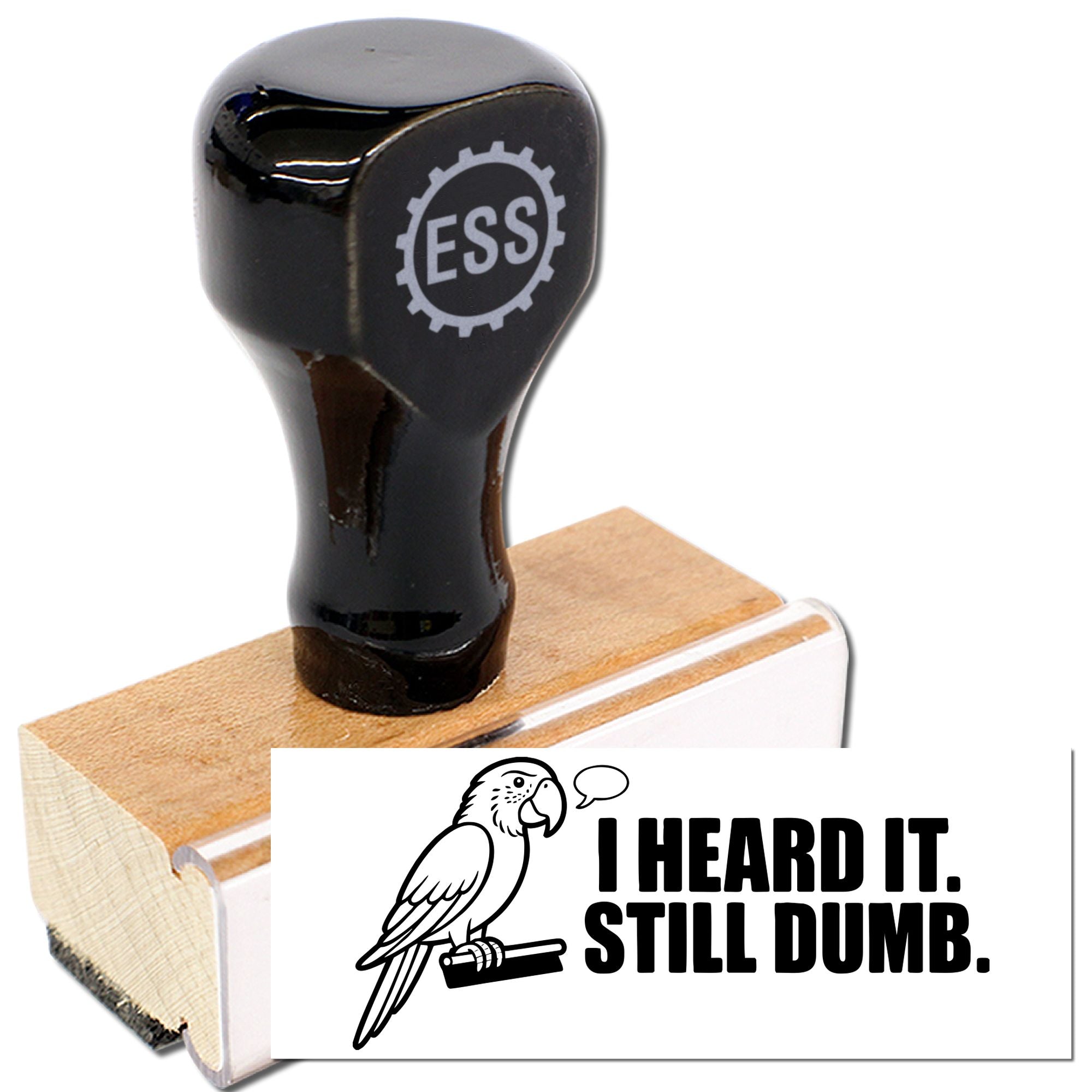 Black self-inking rubber stamp with ESS gear logo on wooden base, beside a white seal card reading I HEARD IT. STILL DUMB.