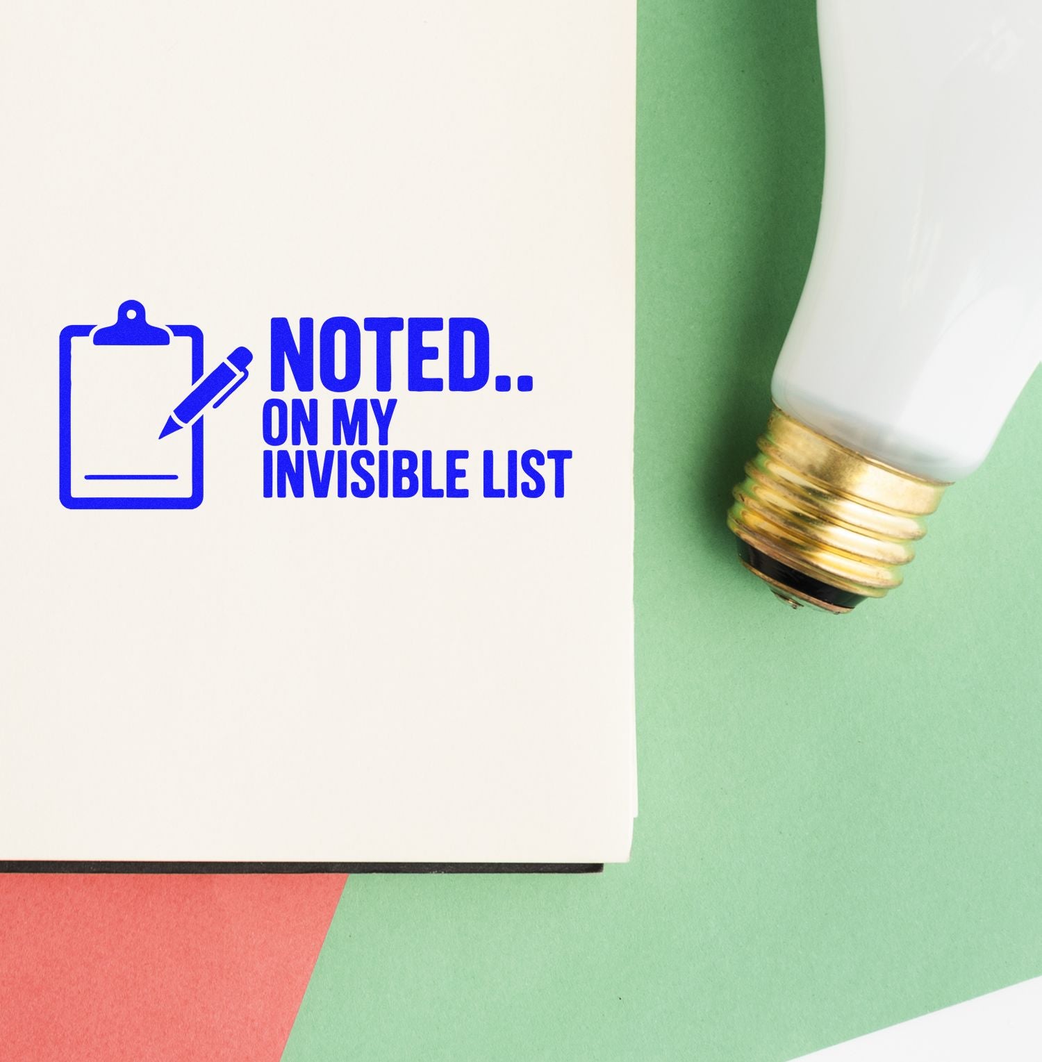 Blue custom stamp reading Noted.. On My Invisible List with clipboard icon, beside a white-and-gold seal stamp on green paper.