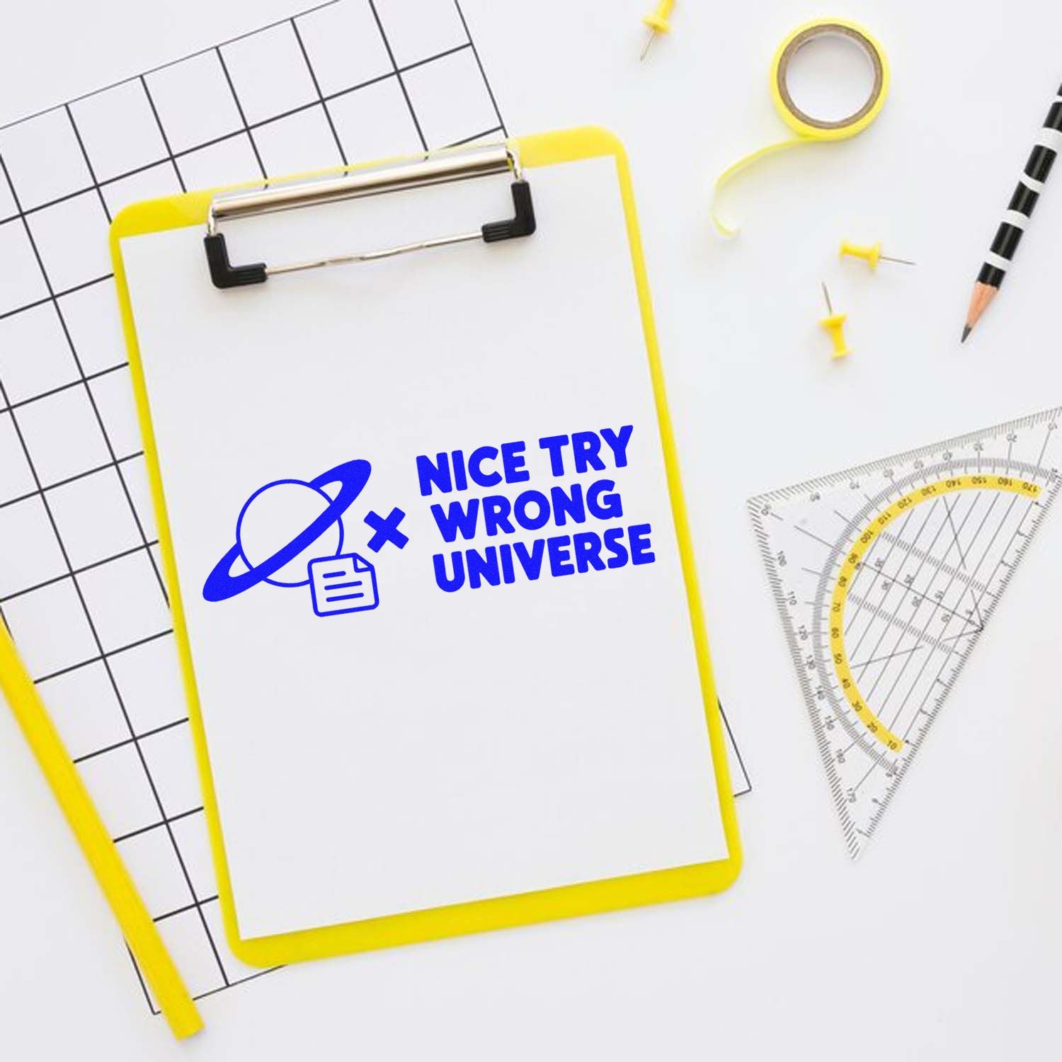 Blue custom stamp and seal on a yellow clipboard, with planet icon, ruler, pencil, and grid paper.