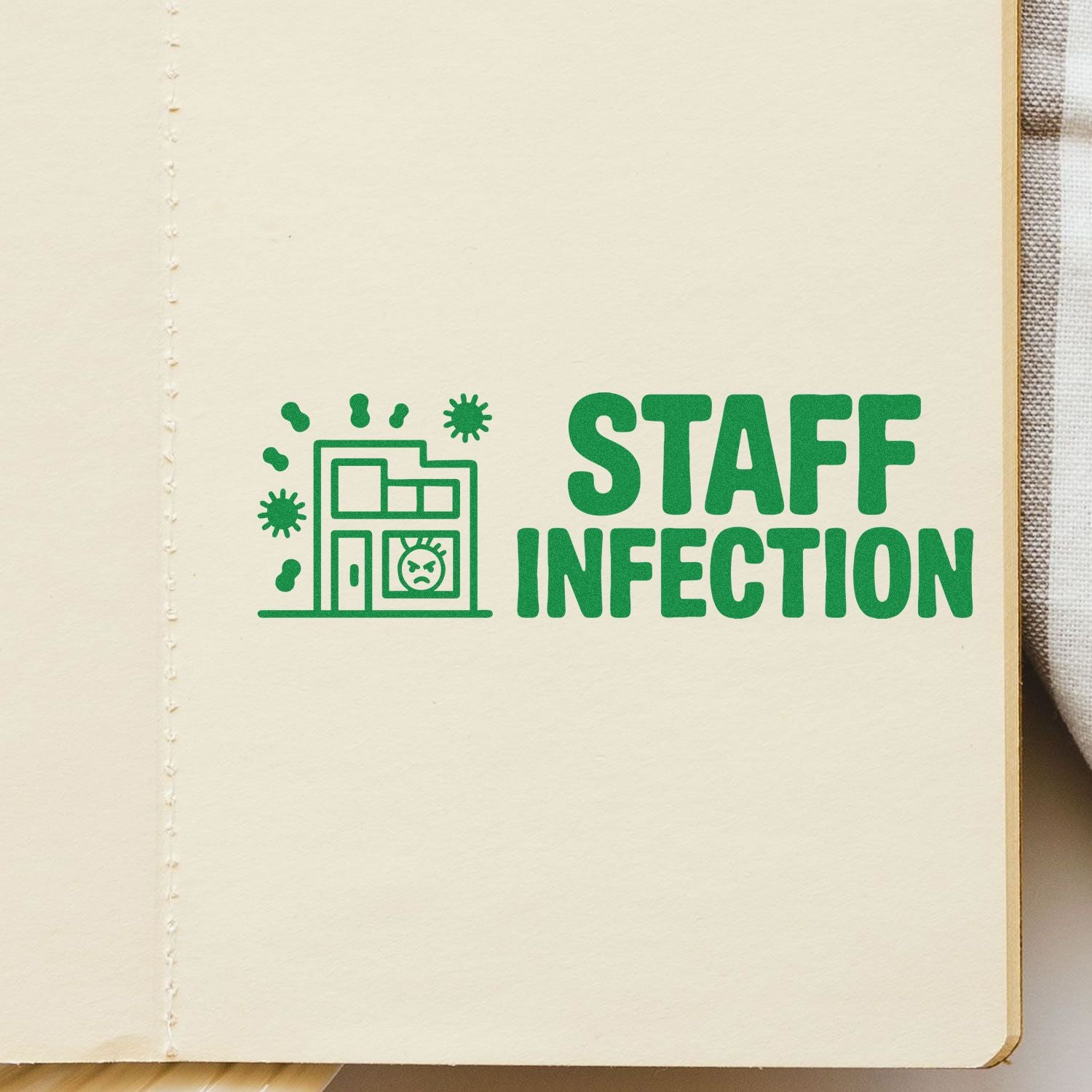 Green STAFF INFECTION stamp seal with office building icon and virus symbols on cream notebook page.
