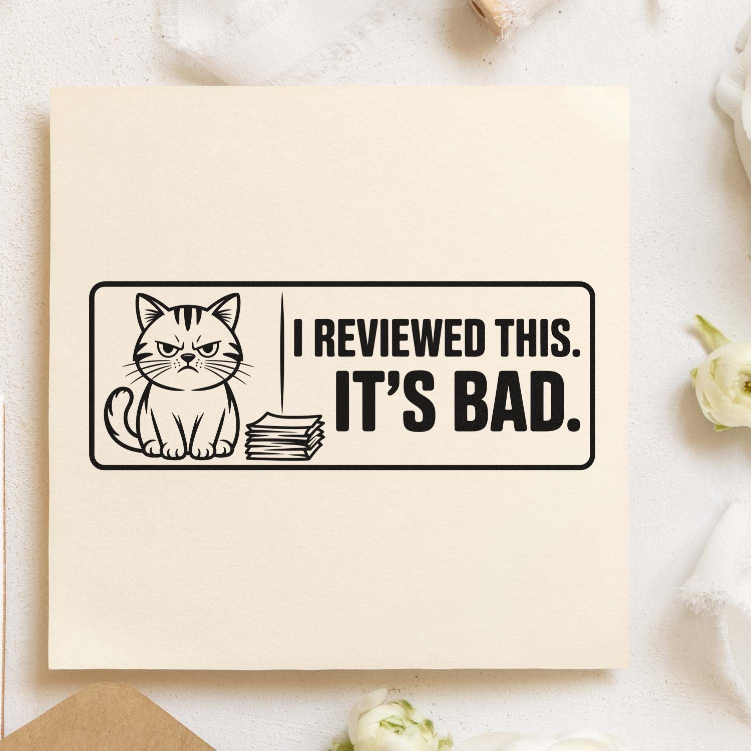 Black cat review stamp seal in black on cream paper, with bold text: I reviewed this. Its bad.
