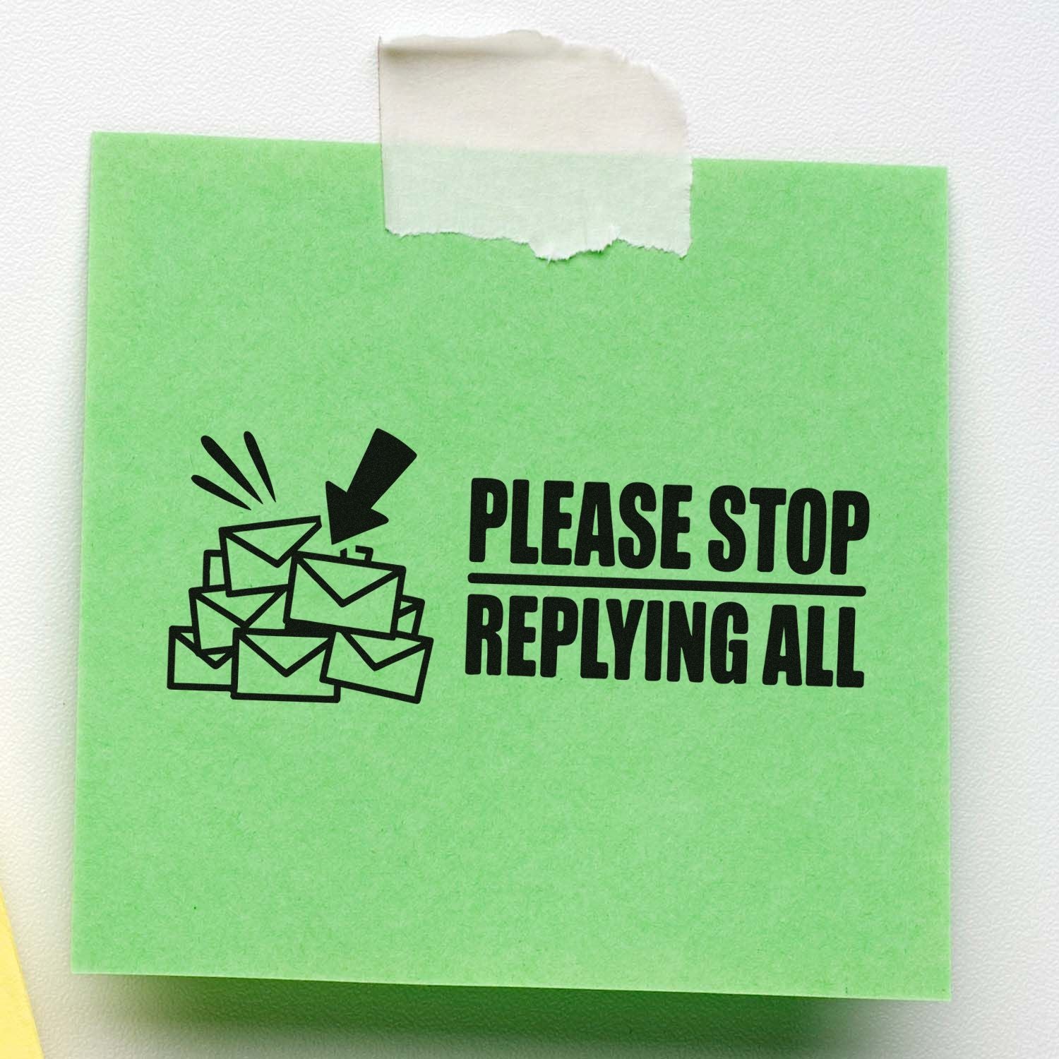 Green sticky note stamp seal with black envelope icon and bold Please Stop Replying All text, taped at top.