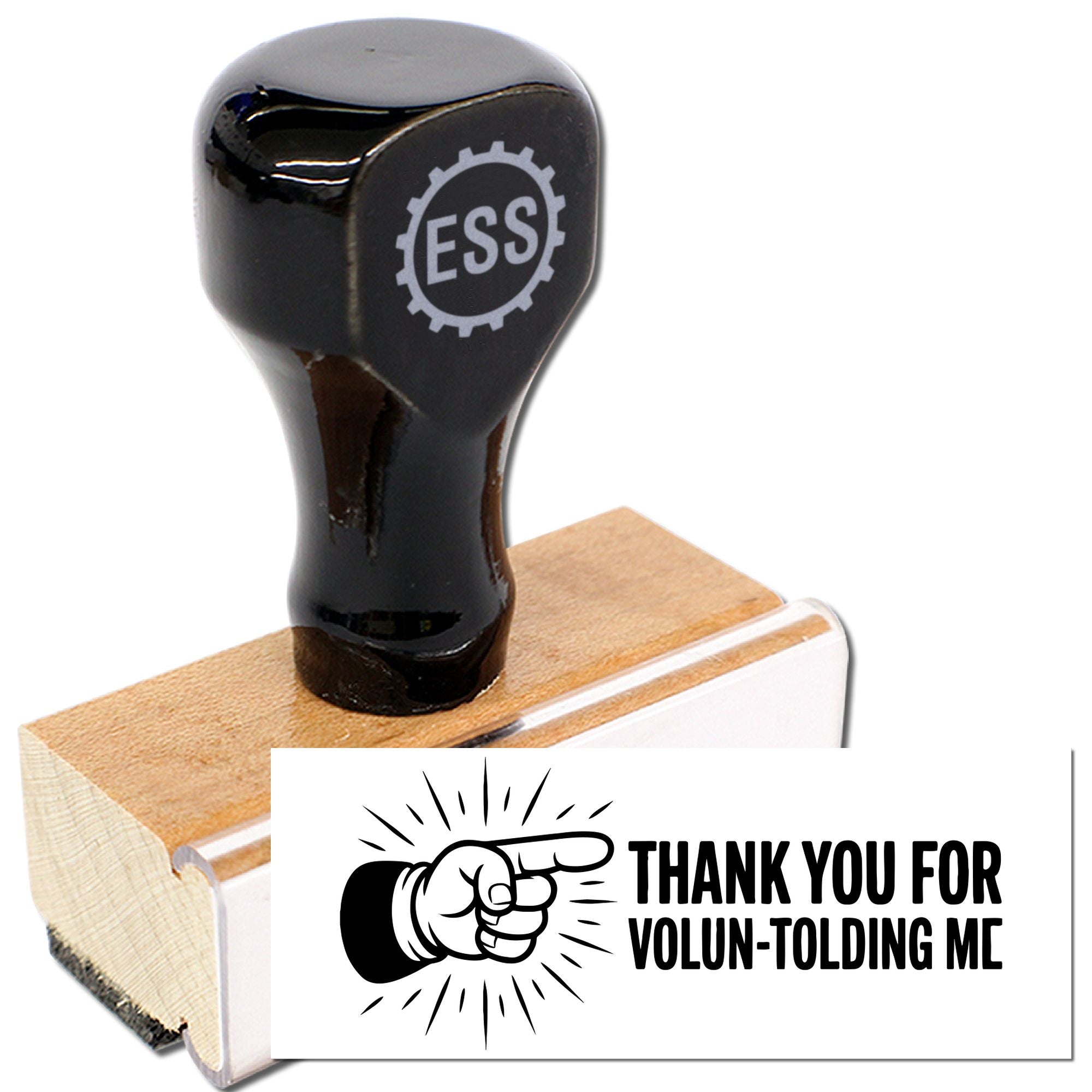 Black rubber stamp and seal on wooden block, with pointing hand graphic and bold Thank You for Volun-tolding Me imprint.
