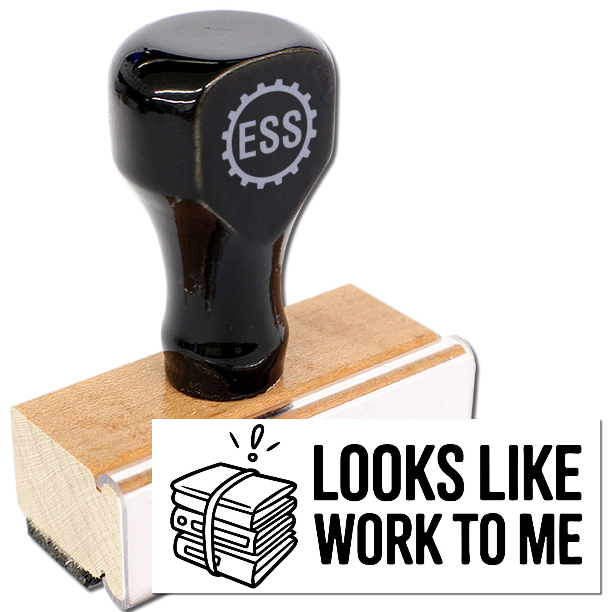 Black stamp and seal on wooden block, printing LOOKS LIKE WORK TO ME in bold black text with icon.