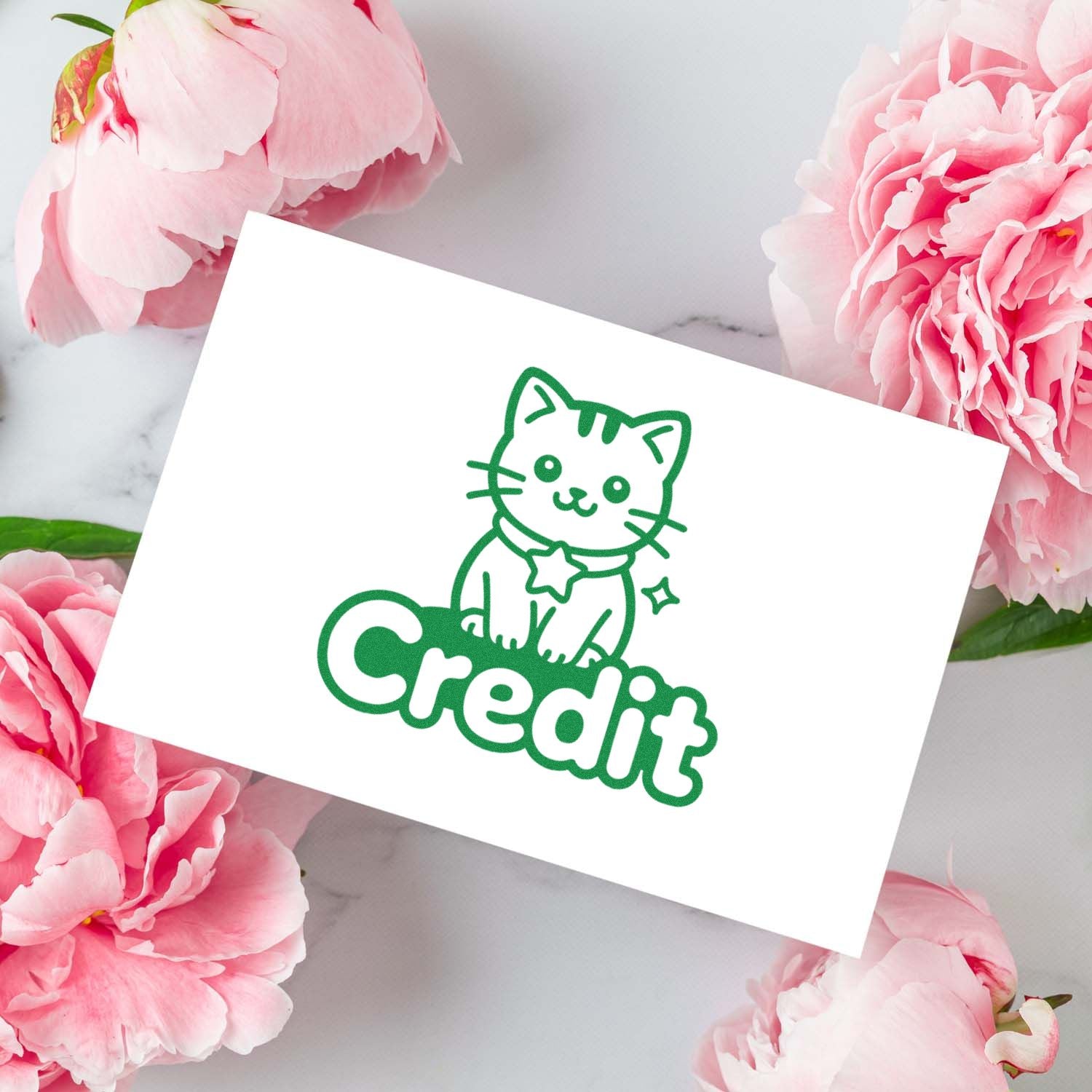 Green cat Credit stamp and seal design on white card, surrounded by pink peonies.