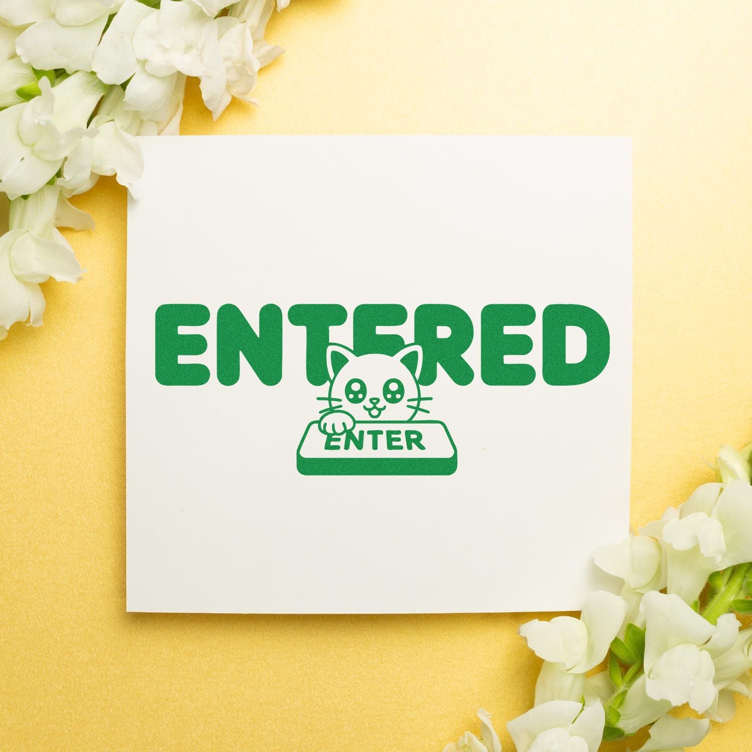 Green ENTERED cat stamp seal on white card, with ENTER key graphic, yellow background, and white flowers.