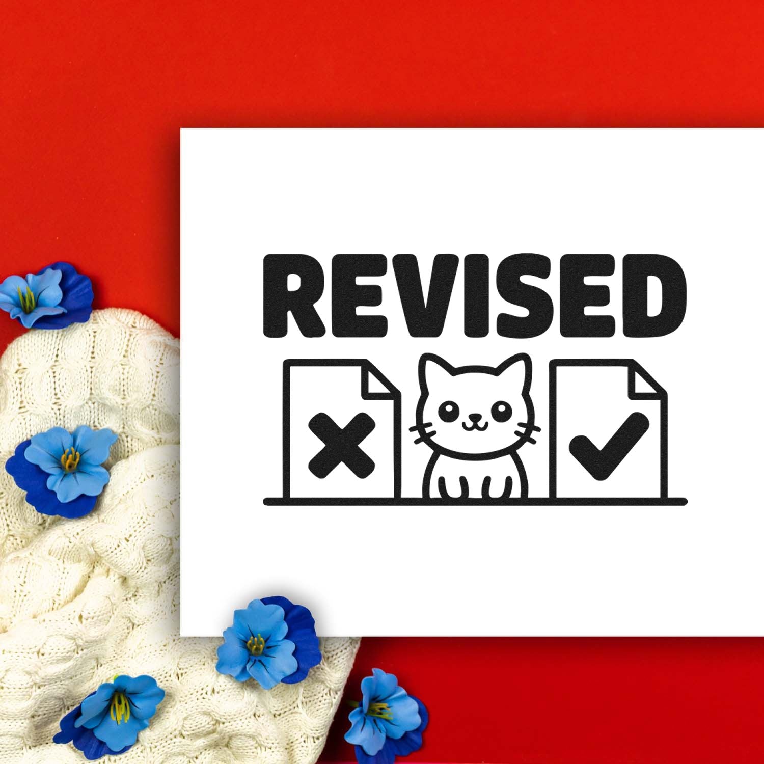 Revised stamp and seal design with black cat, X and check marks on white card, set on a red background with blue flowers.
