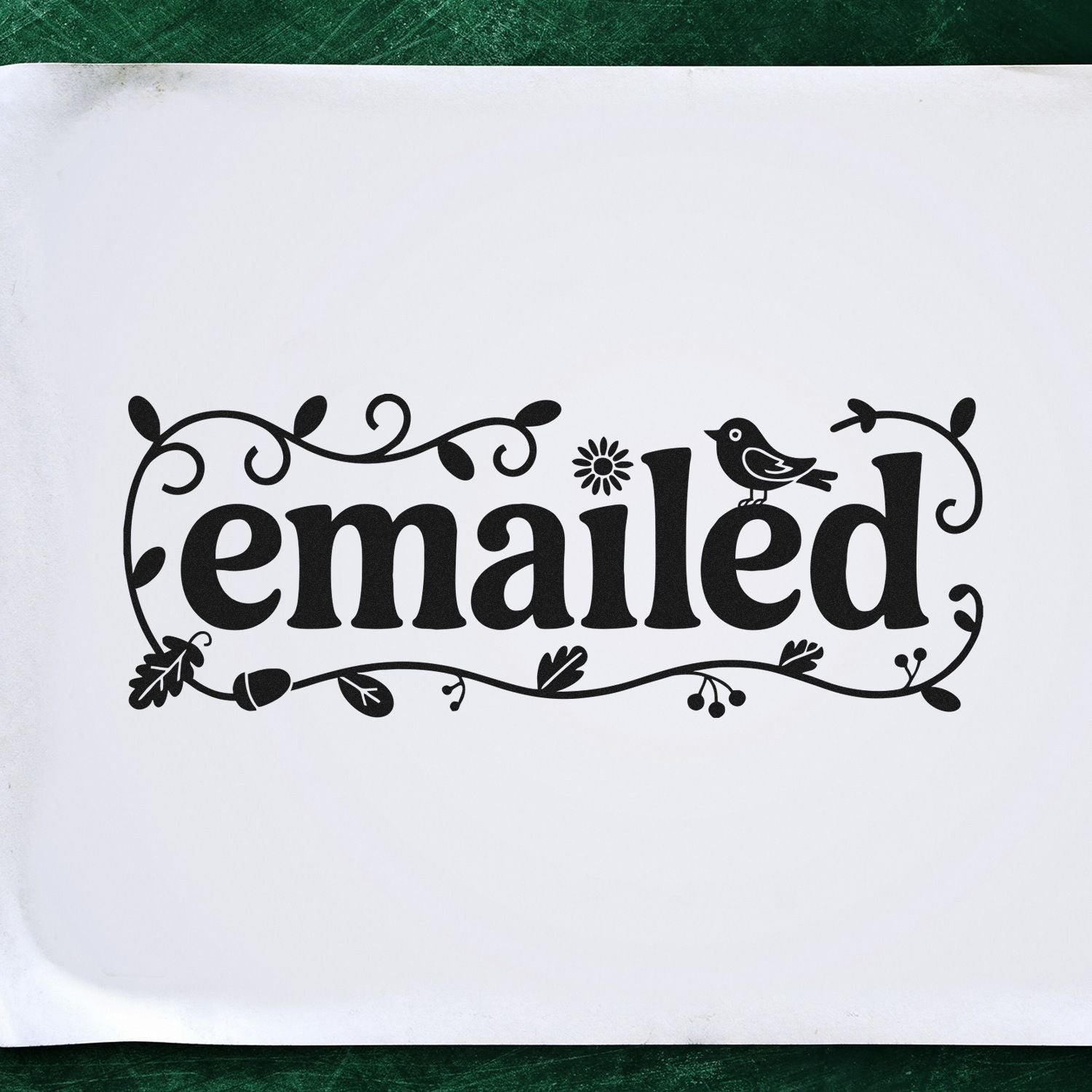 Black decorative emailed stamp seal with bird and vine flourishes on a white background