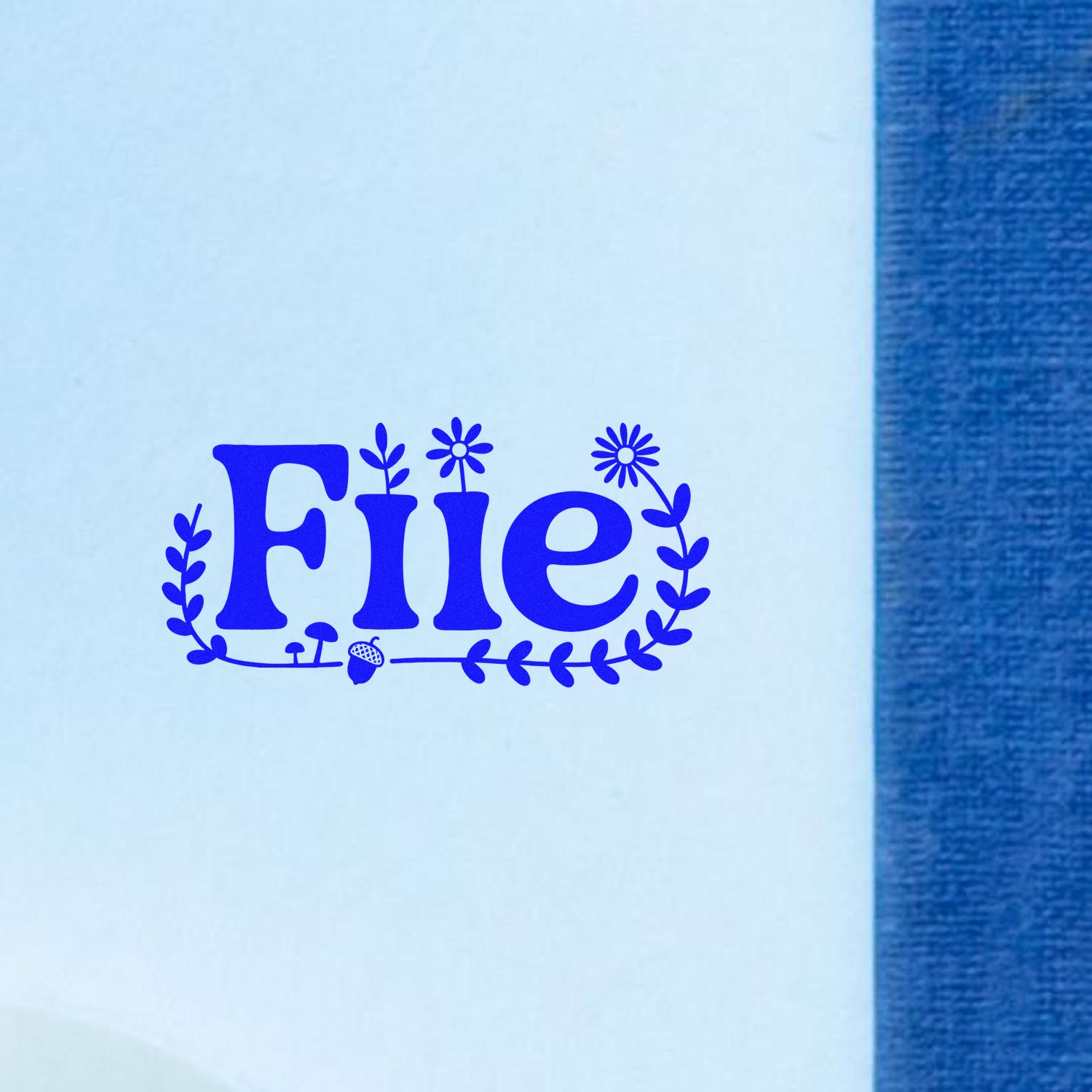 Blue FILE stamp seal with floral wreath on white paper beside a textured blue edge