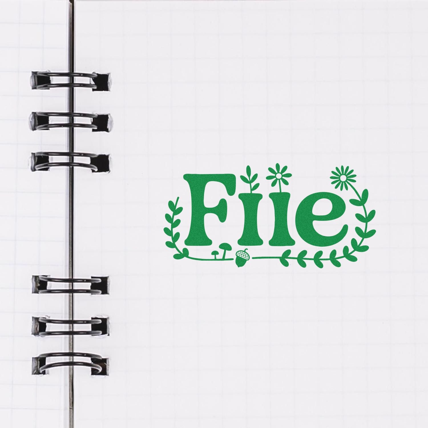 Green floral File stamp design on white notebook page with black spiral binding