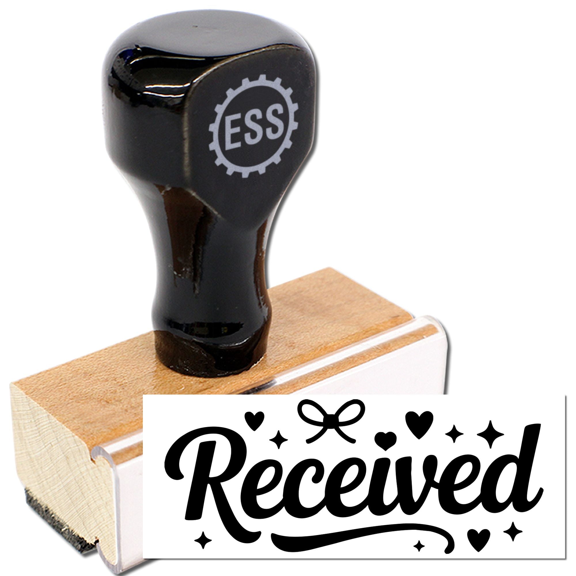 Black ESS rubber stamp and seal on a wooden base, printing Received in black script with hearts, stars, and bow on white