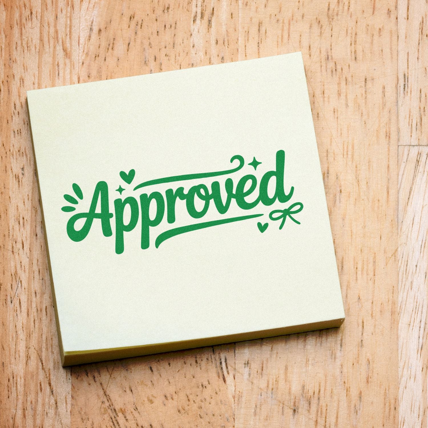 Cream rubber stamp block with green Approved seal and heart accents on a wood background