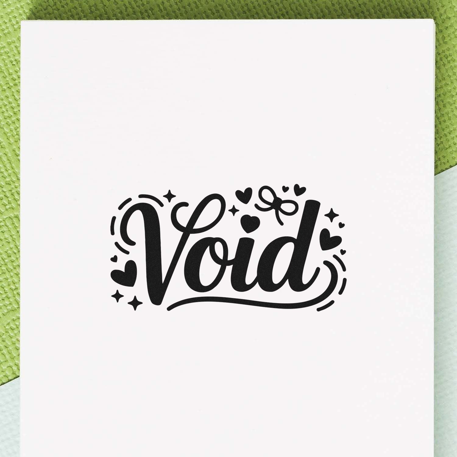 Black Void stamp and seal design with hearts and sparkles on a white card, set against a green textured background.