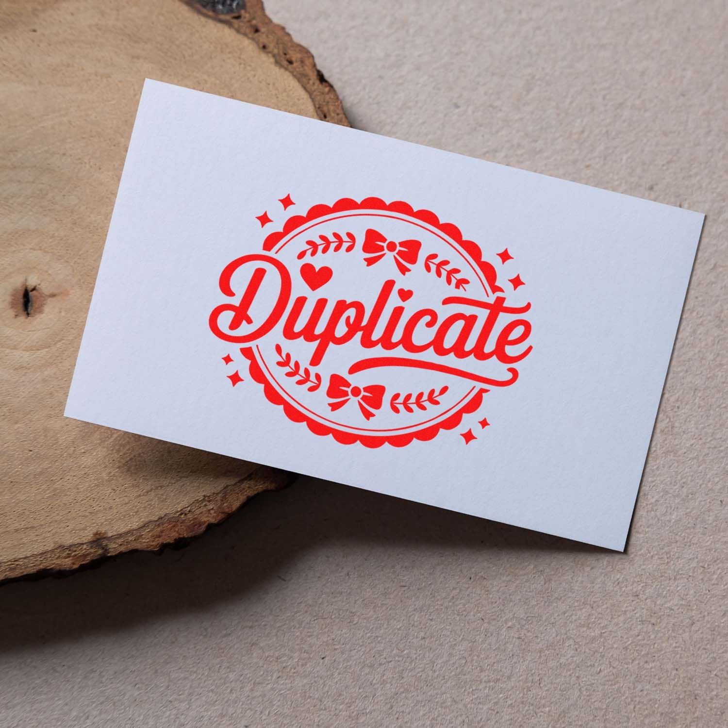 White card with red decorative Duplicate stamp seal featuring hearts, bows, and stars on rustic wood background.