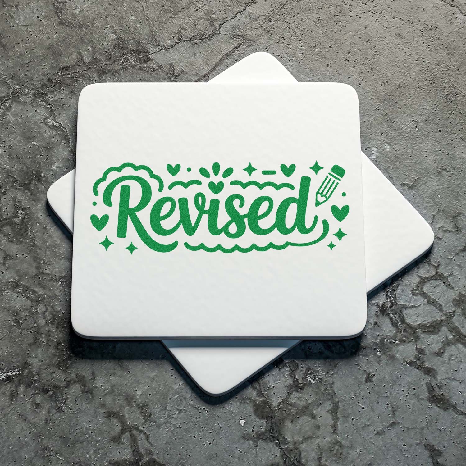 White stamp and seal tiles with green Revised script, hearts, stars, and pencil on gray textured background.