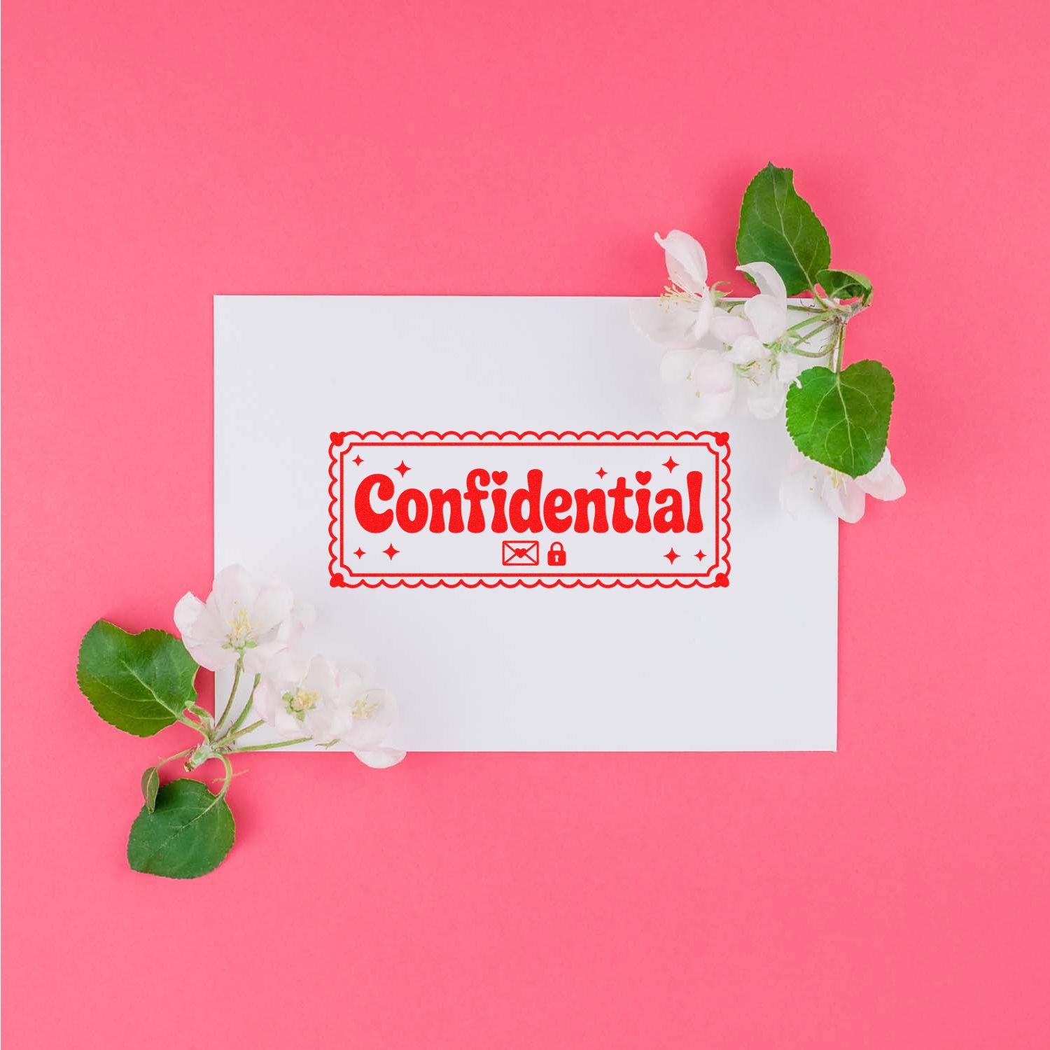 Red confidential stamp seal on white card with white blossoms and green leaves against a bright pink background.