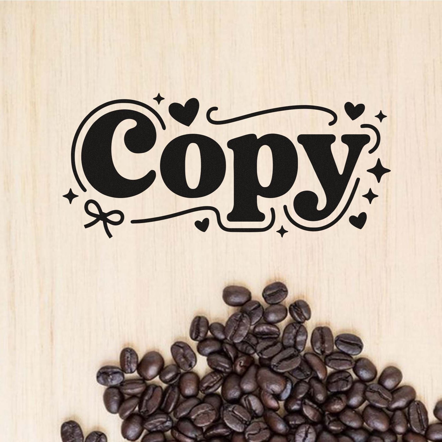 Black decorative Copy stamp seal in black on light wood, with hearts and stars above scattered coffee beans.