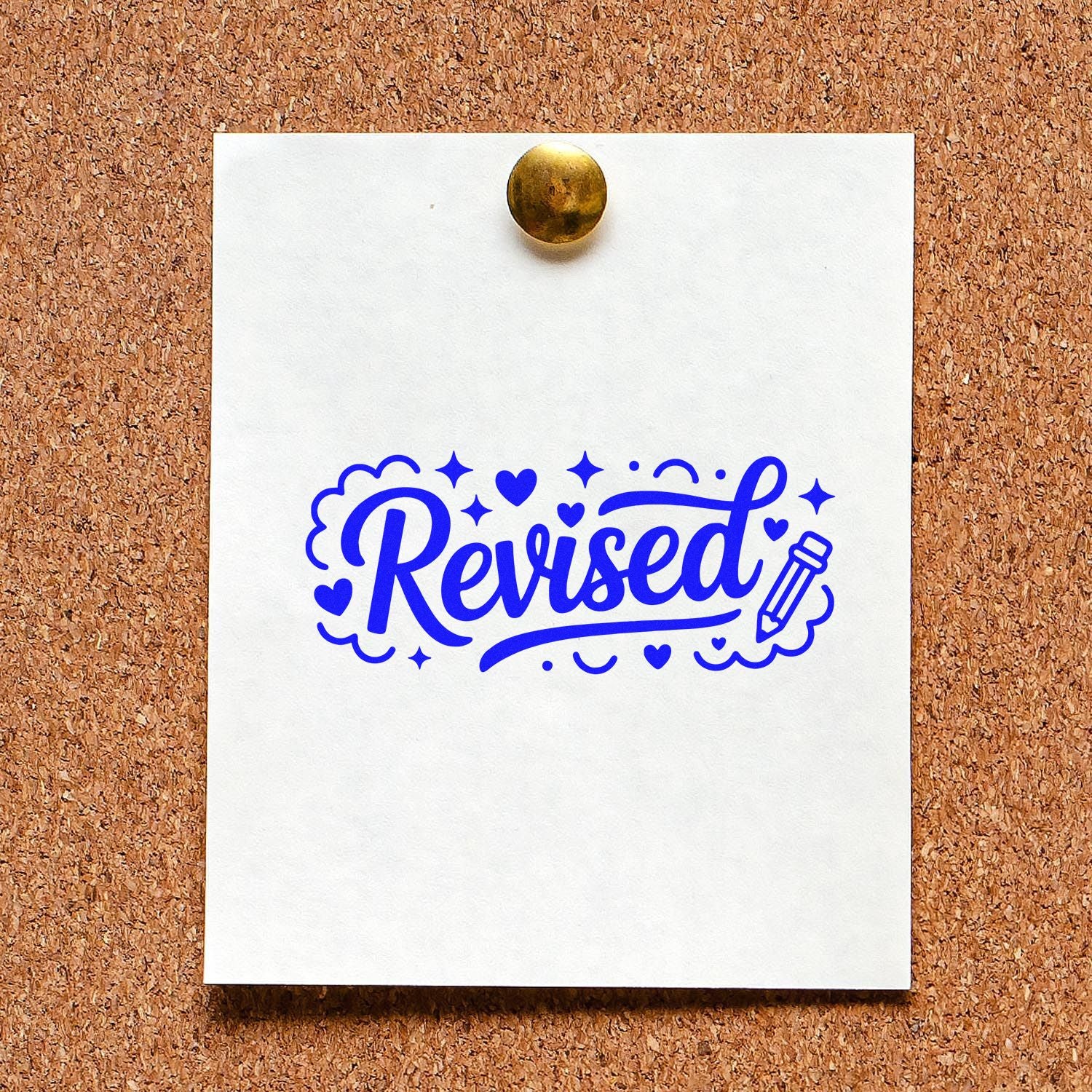Blue Revised stamp/seal in bold blue with hearts and pencil, pinned on white paper with a gold tack against corkboard.