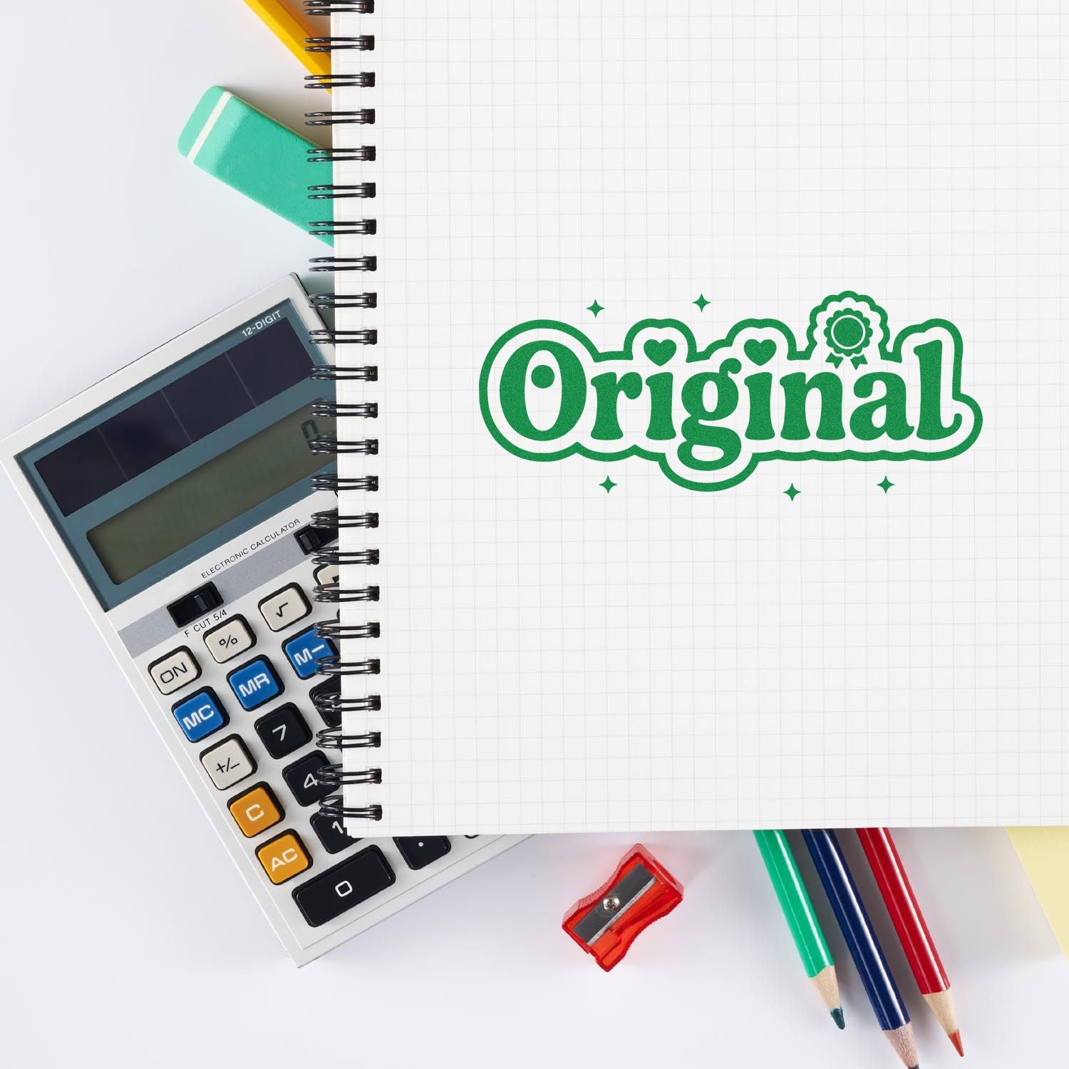 Green Original stamp seal on a notebook beside a calculator, pencils, and a sharpener.
