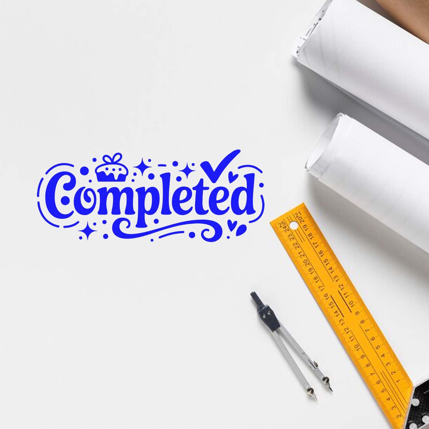 Blue Completed stamp seal on white paper with a yellow ruler and metal compass, showing office stationery tools.