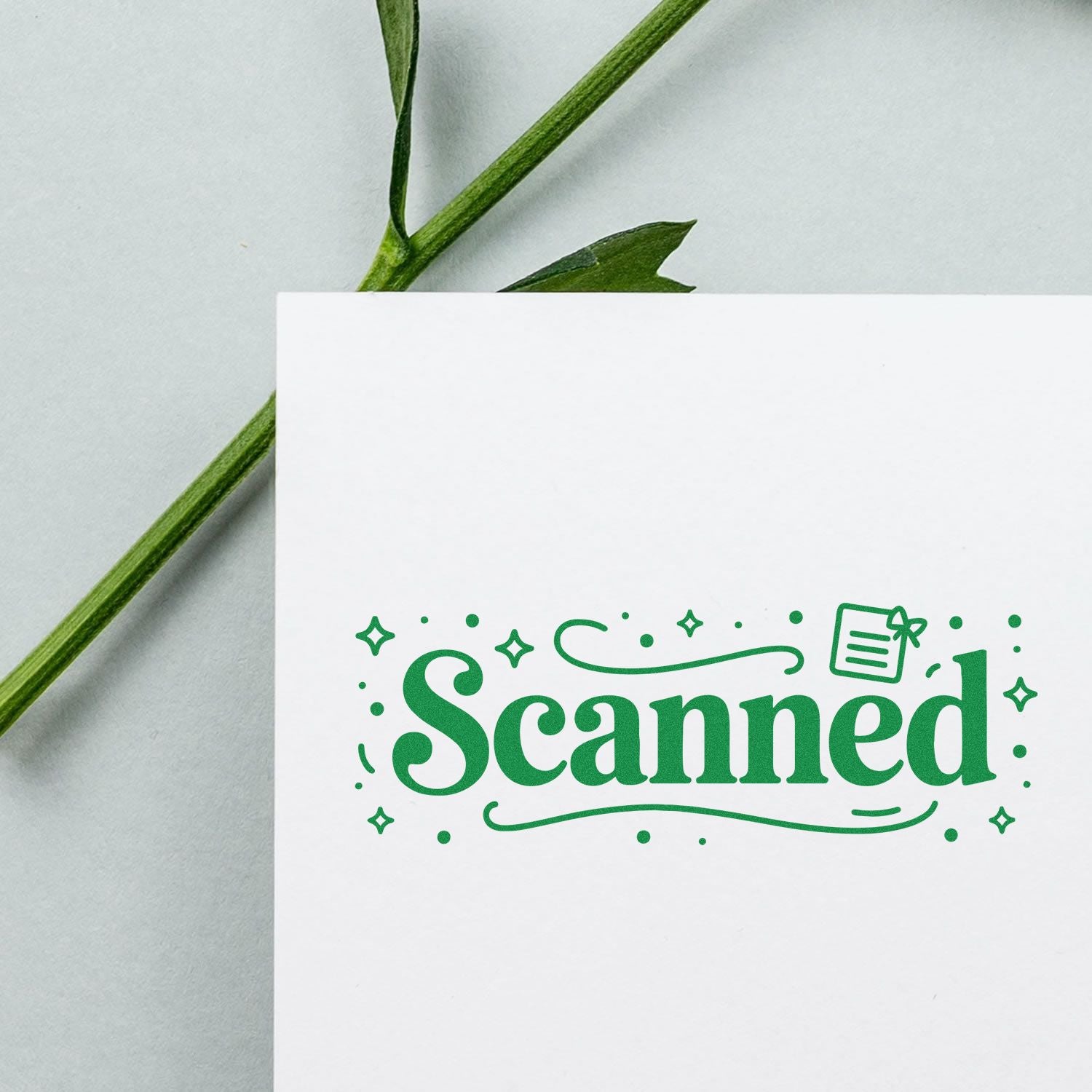 Green decorative Scanned stamp seal on white card with leaf stem against pale background