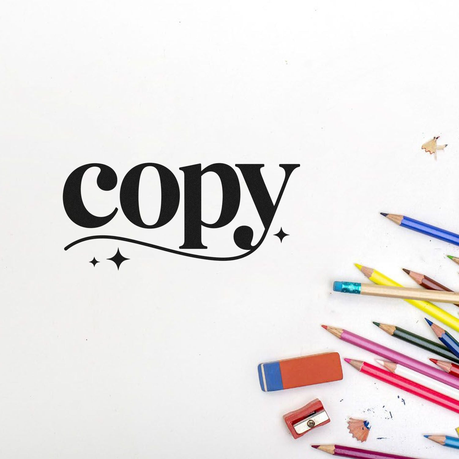 Black copy stamp and seal design with colored pencils, eraser, and sharpener on white background.