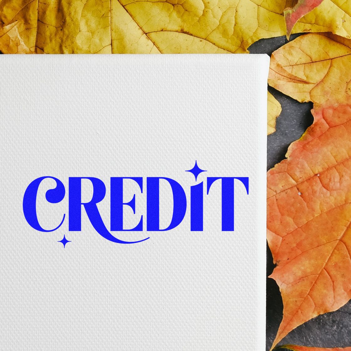 Blue CREDIT stamp and seal on textured white card with orange and yellow autumn leaves.