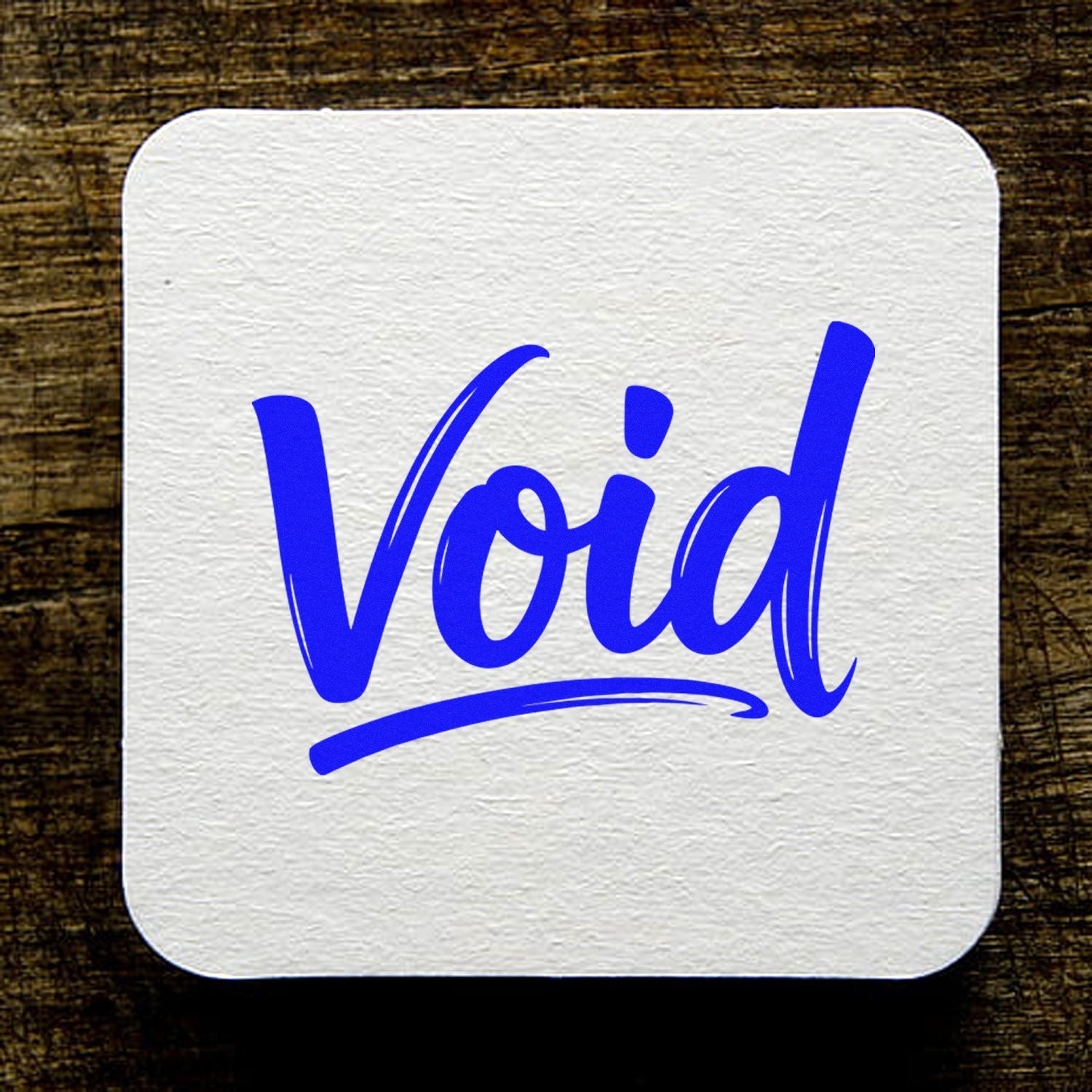 White textured stamp seal with bold blue Void lettering and underline on a dark wood background.