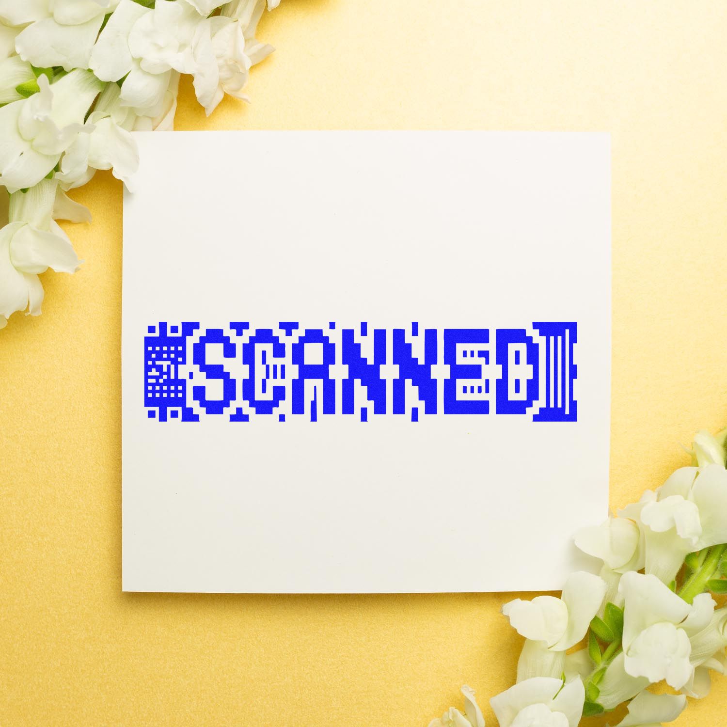 White card with blue SCANNED stamp, on a pale yellow background with white flowers.
