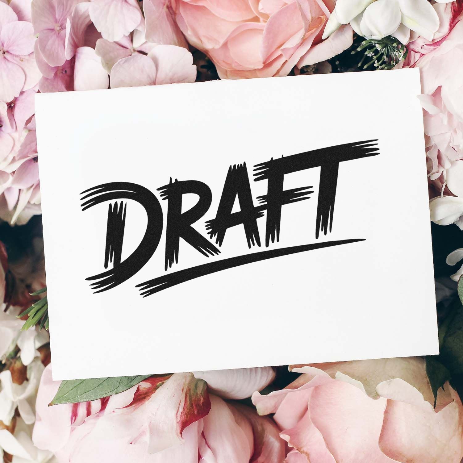 Black DRAFT stamp seal on white card, surrounded by soft pink and white flowers.