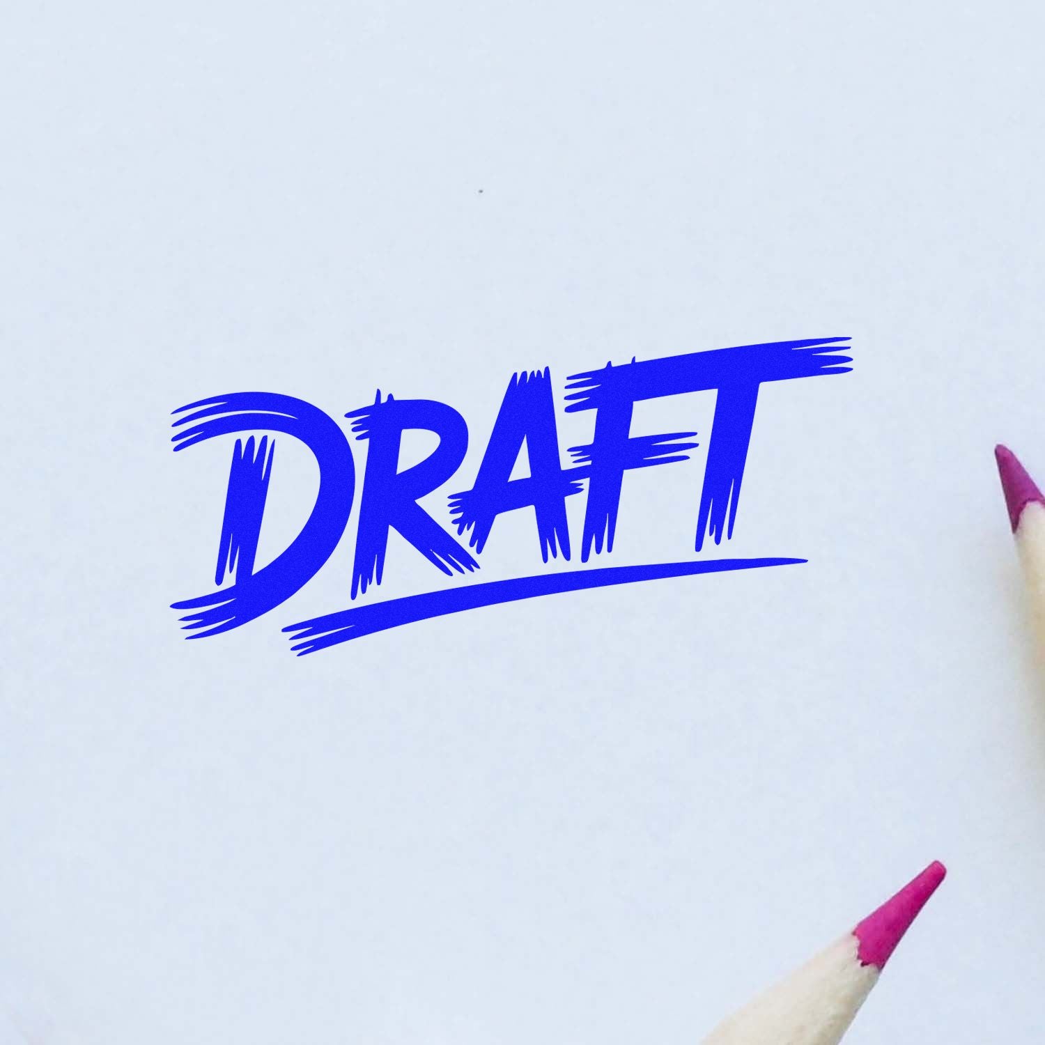 Blue DRAFT rubber stamp and seal on white paper, with pink pencil tips at the edges.